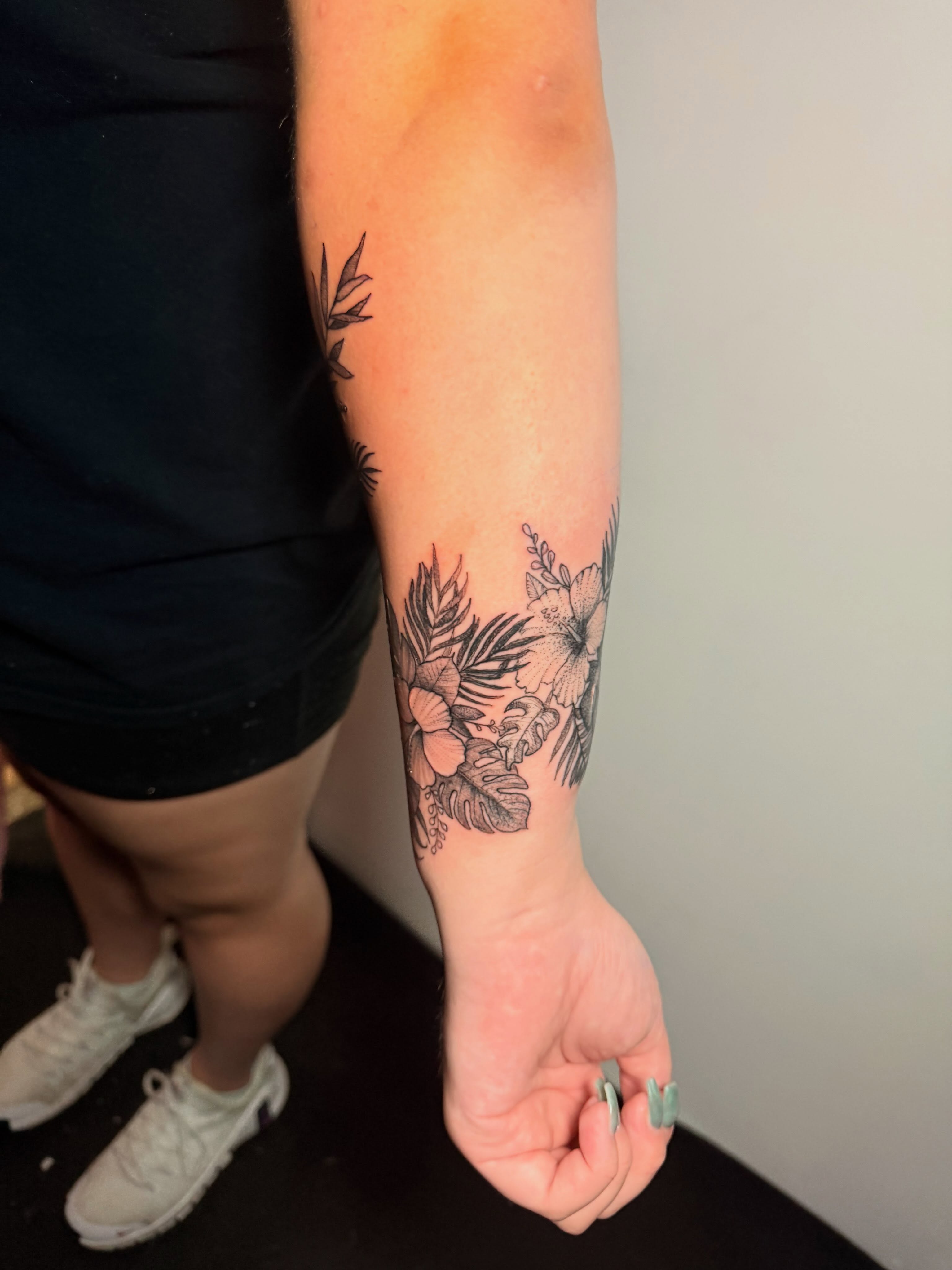 Floral arrangement black and grey tattoo on the forearm by Gabrielle Frelak, York, Pennsylvania