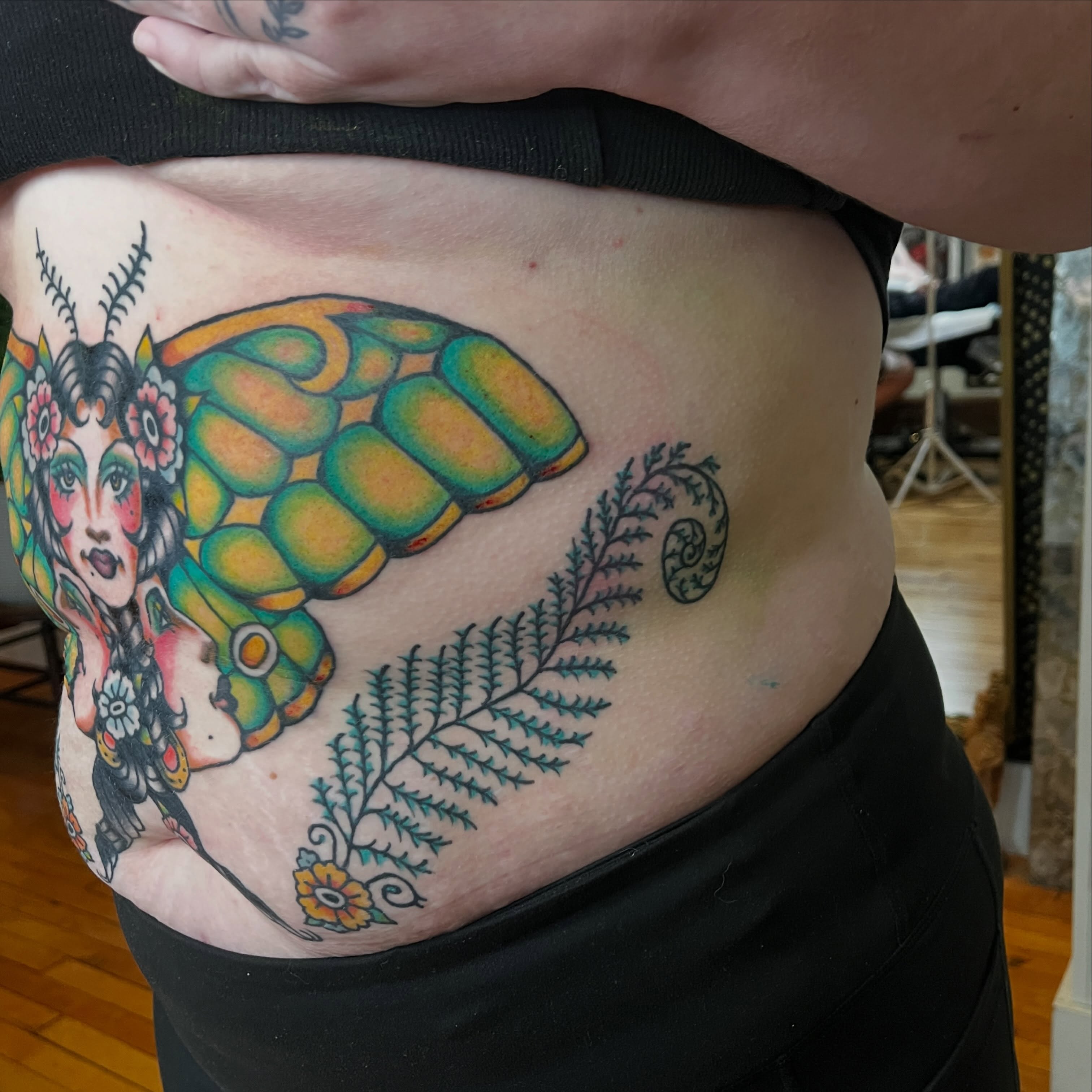 Woman with butterfly wings American traditional tattoo on the torso by madelynne (maddie) caldwell tattoos