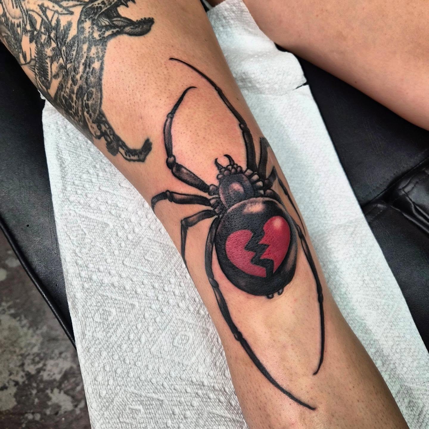 Spider with heart realism tattoo on the forearm by Taylor Popkins