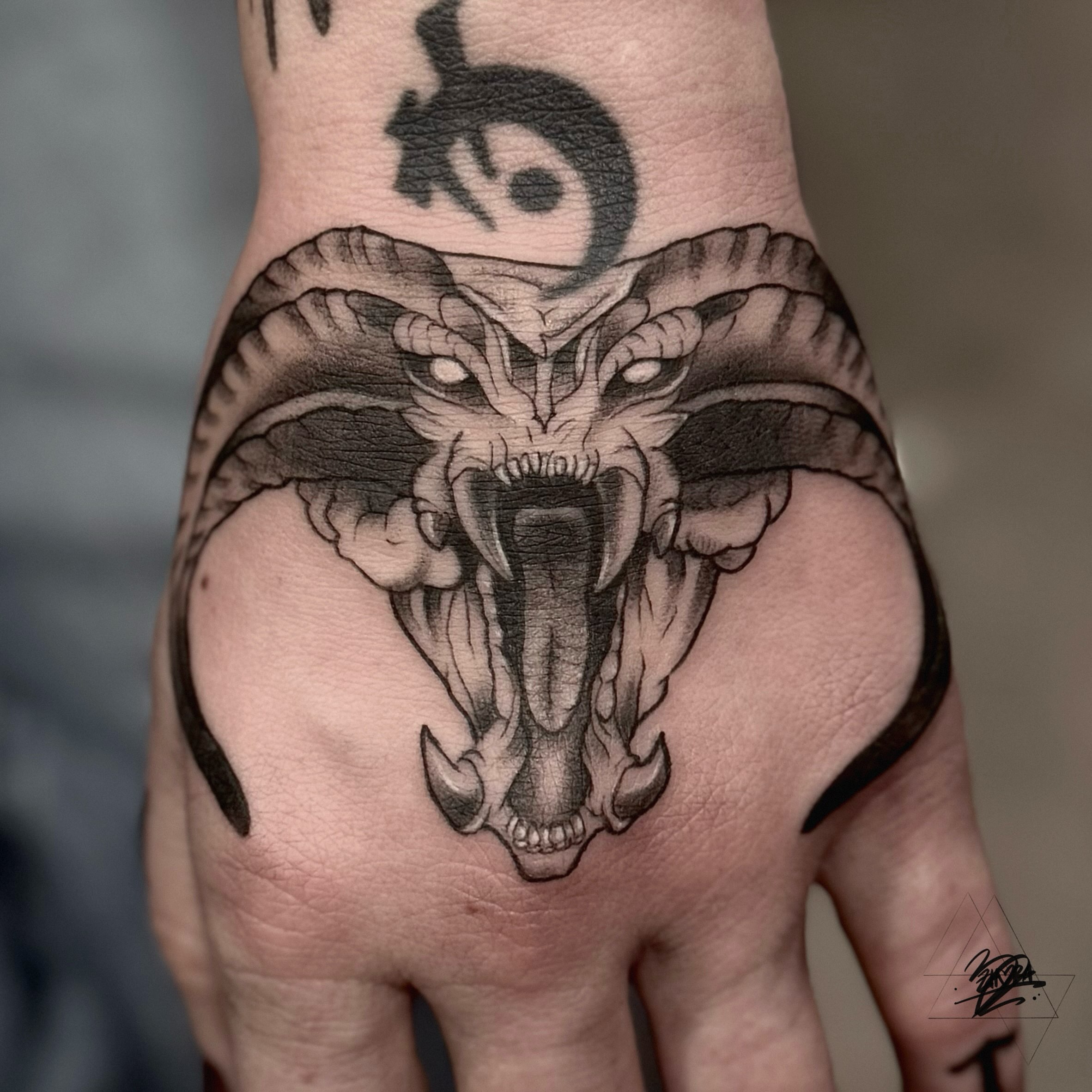 Ram skull black and grey tattoo on the hand by Zhorana Devi