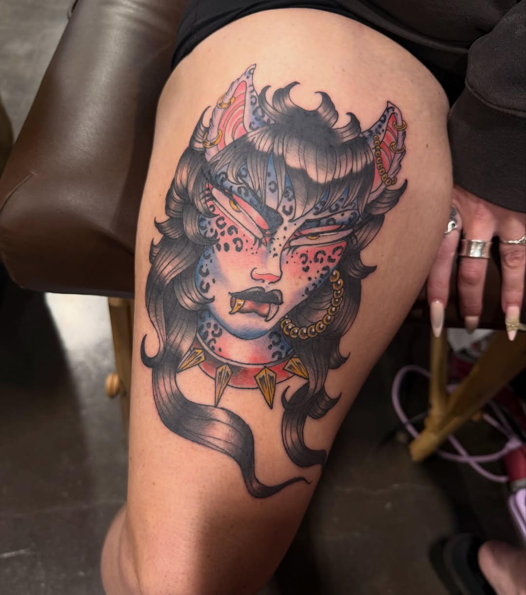 Woman with horns American traditional tattoo on the thigh by Mika Clairissa