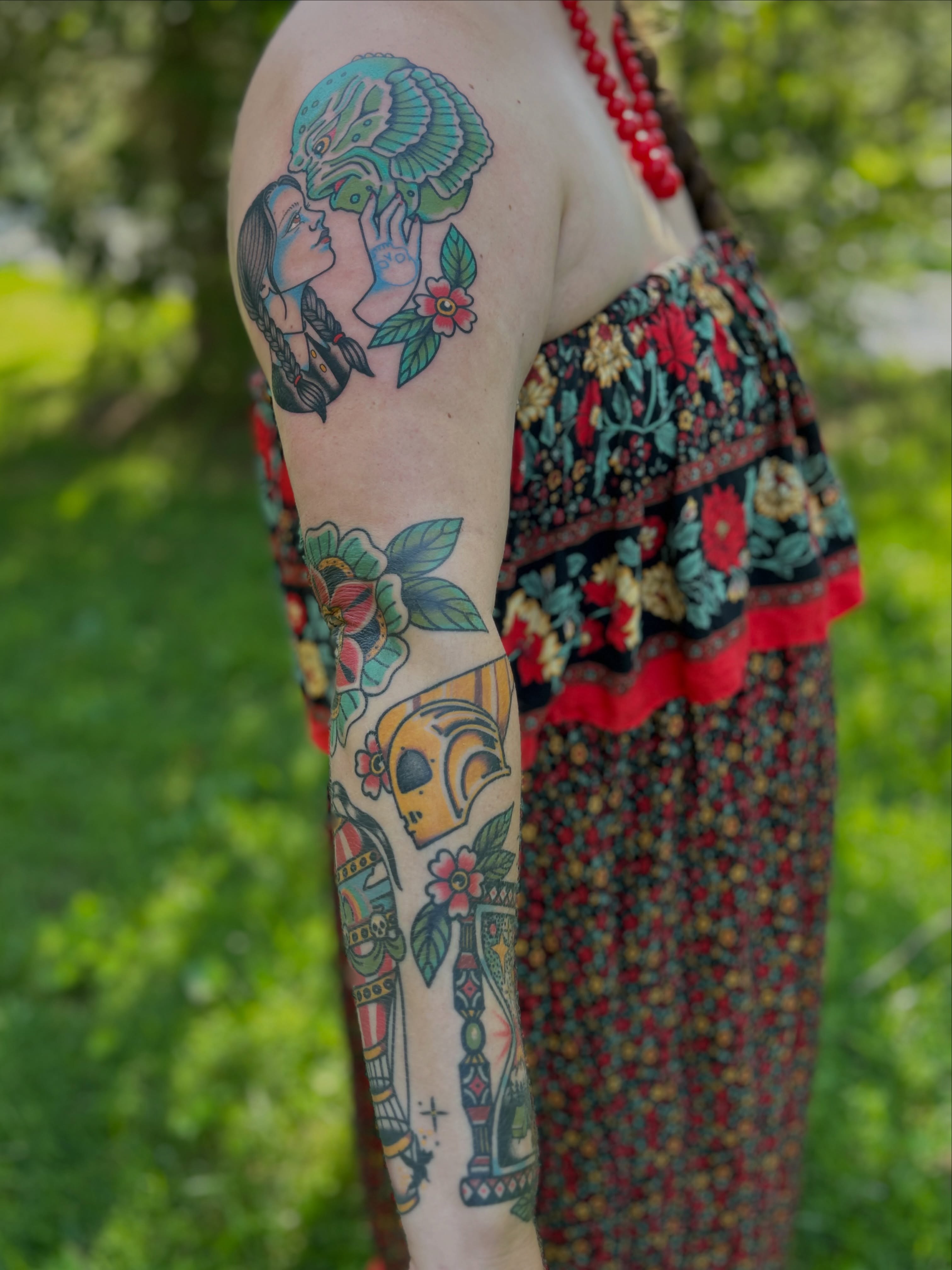 Woman and skull American traditional tattoo on the upper arm by Lauren Alexandra