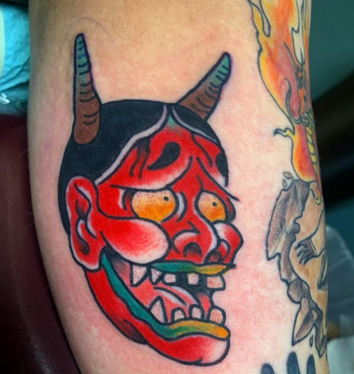 Demon mask American traditional tattoo on the forearm by Arron Albaugh