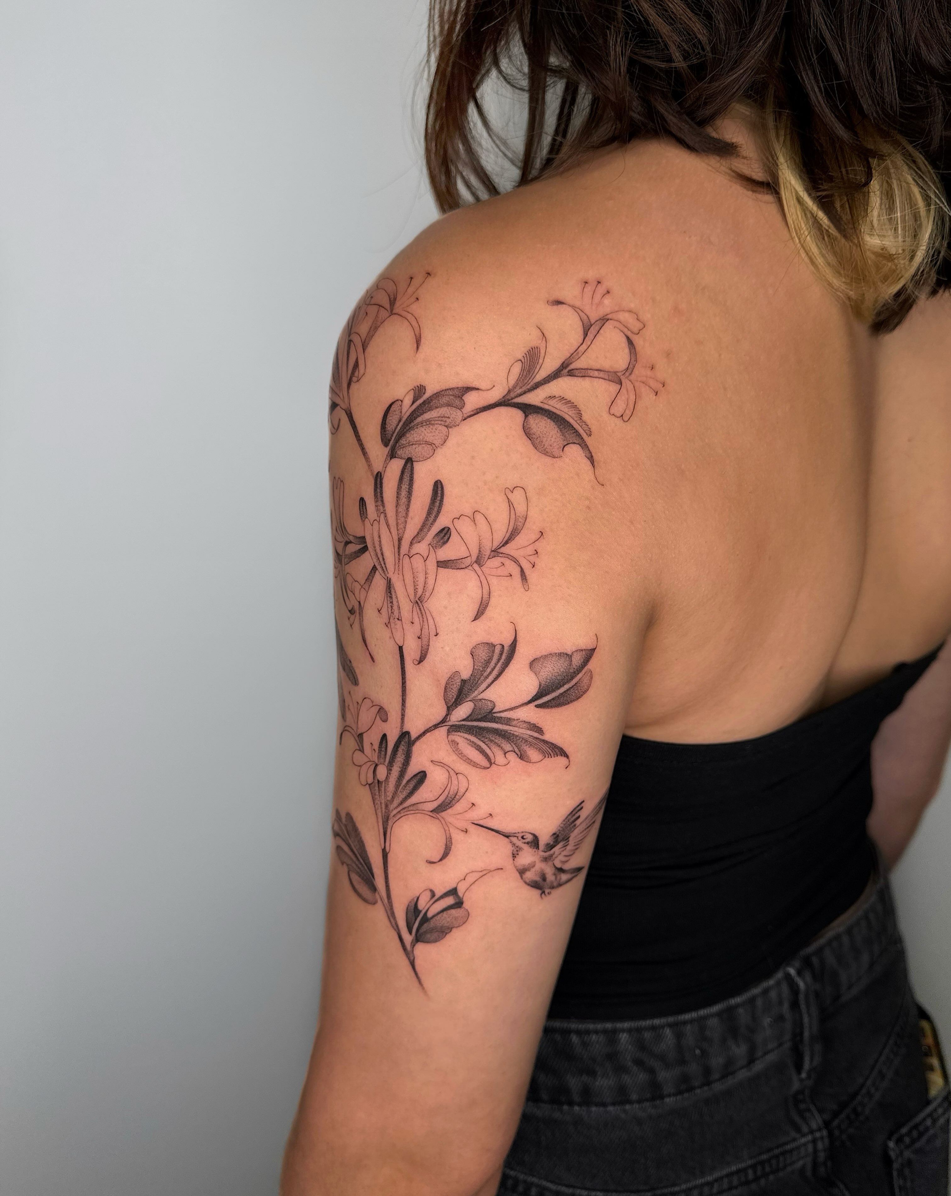 Floral arrangement black and grey tattoo on the shoulder by Alyssa . Villela