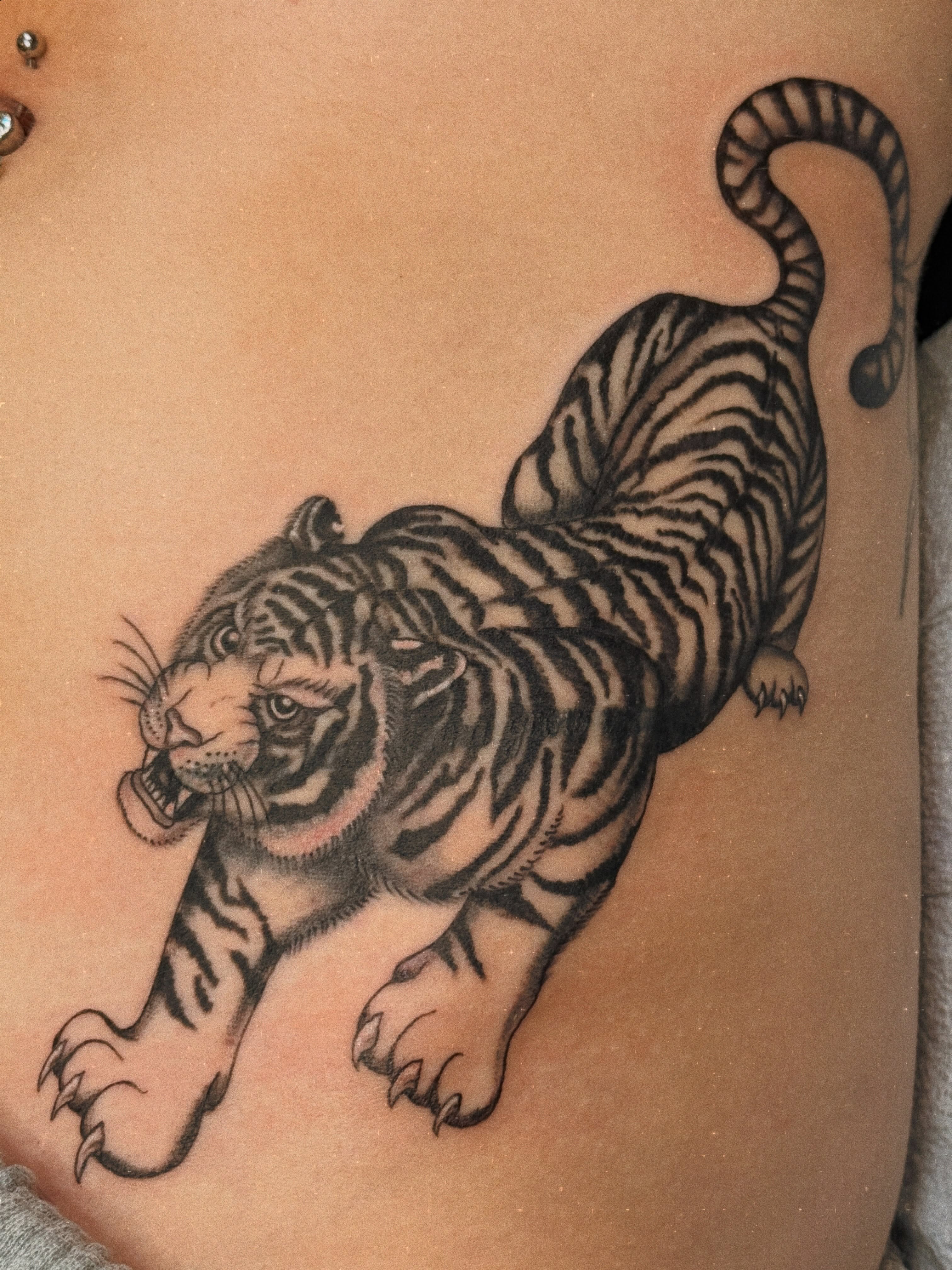 Tiger black and grey tattoo on the ribs by Megan Sue Causemaker