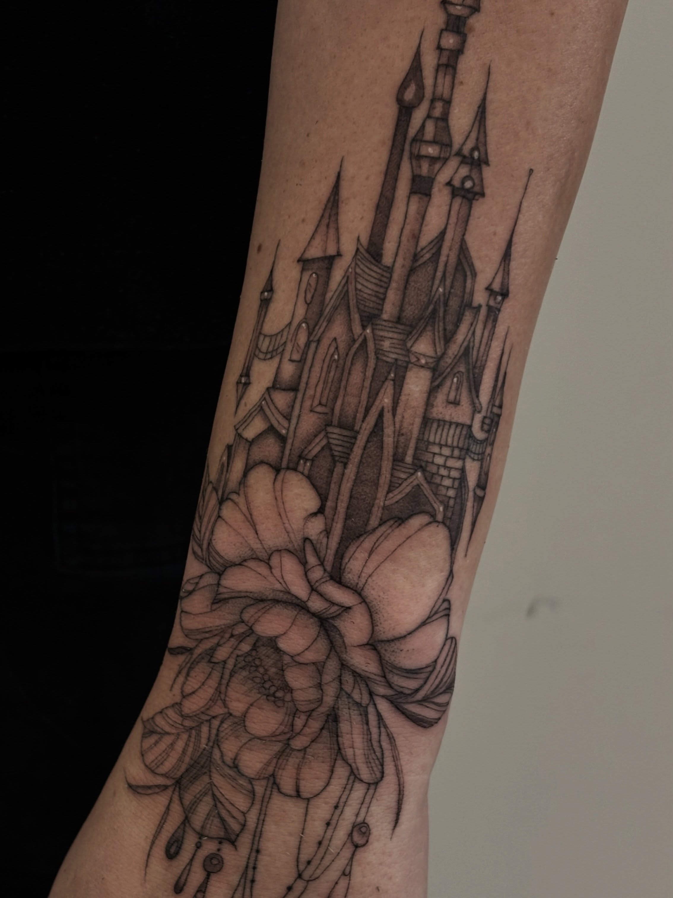 Castle and flower realism tattoo on the forearm by Tayler, Tooele, Utah