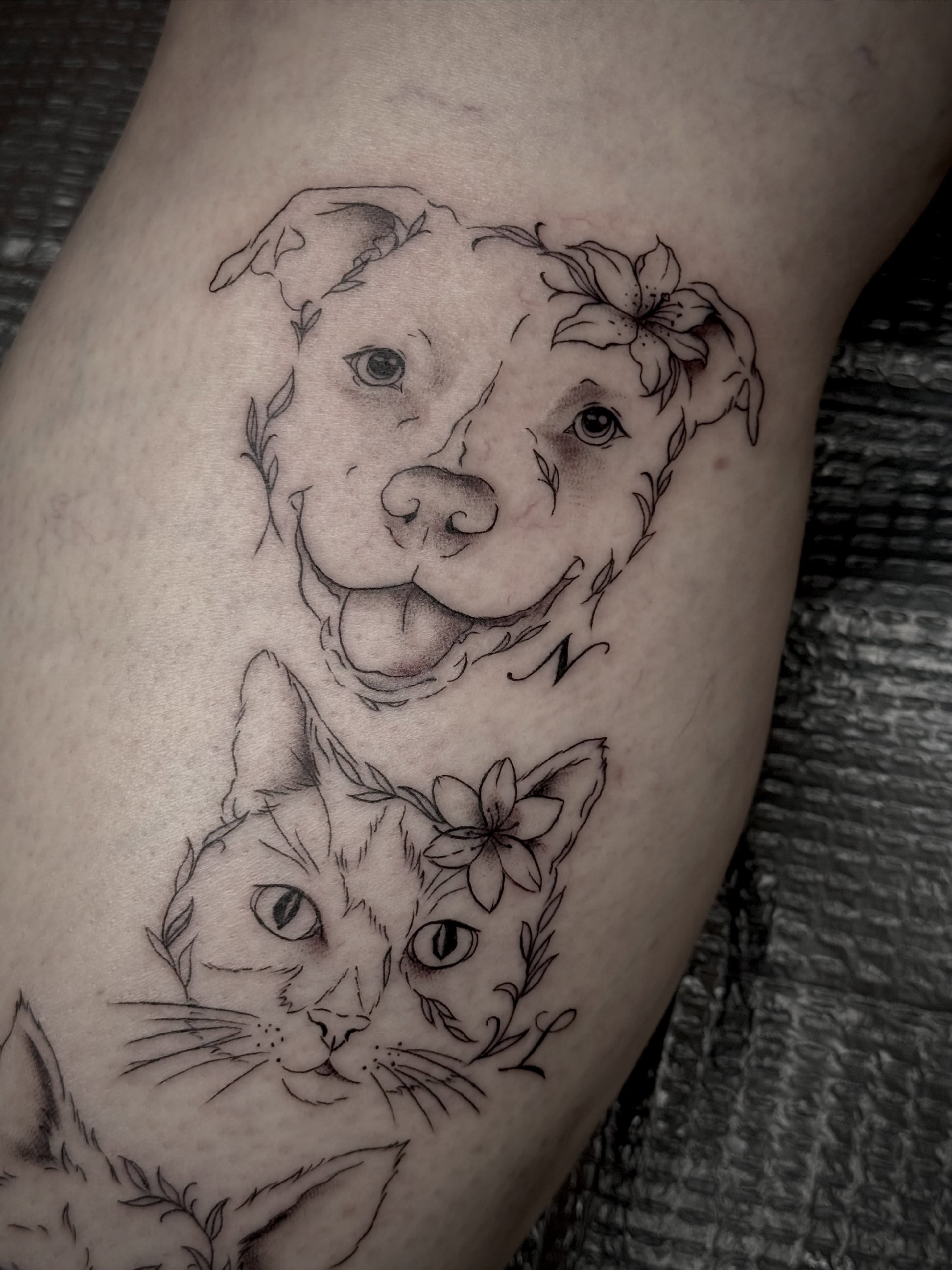 Dog and cat realism tattoo on the thigh by abbie michelle