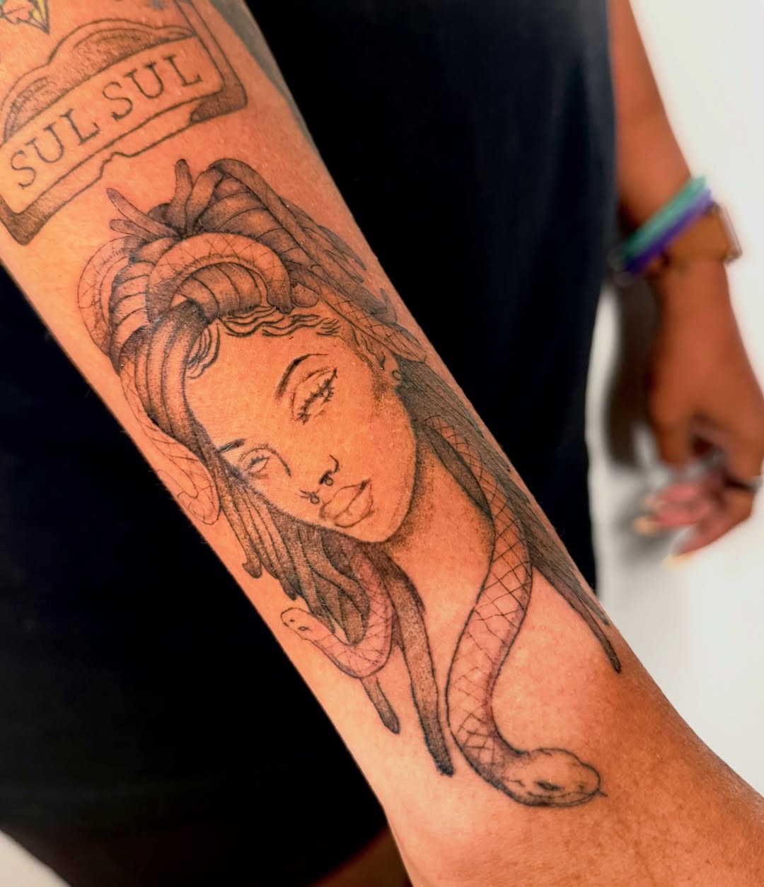 Woman with snake realism tattoo on the forearm by Orca