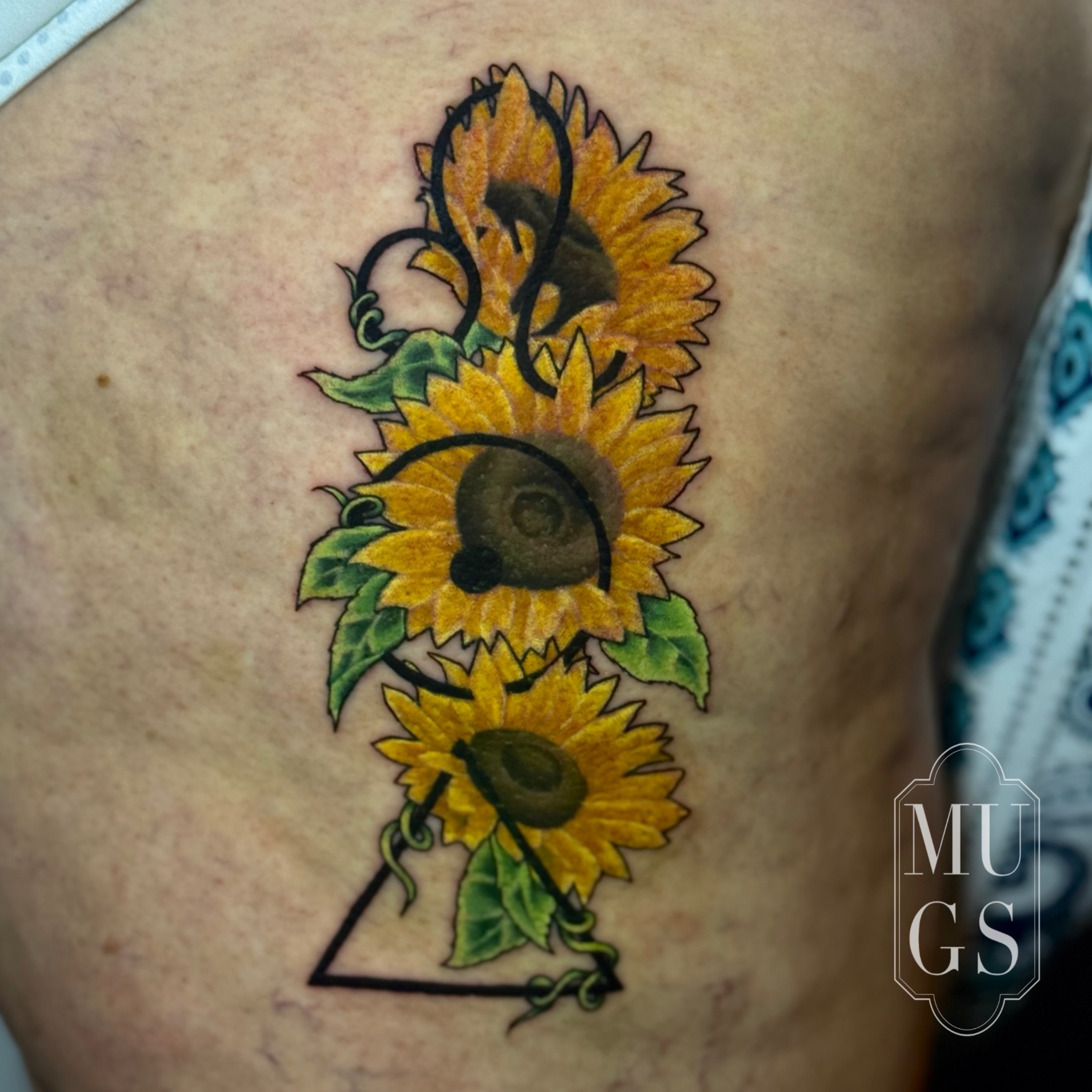 Sunflowers realism tattoo by Emily Andreozzi