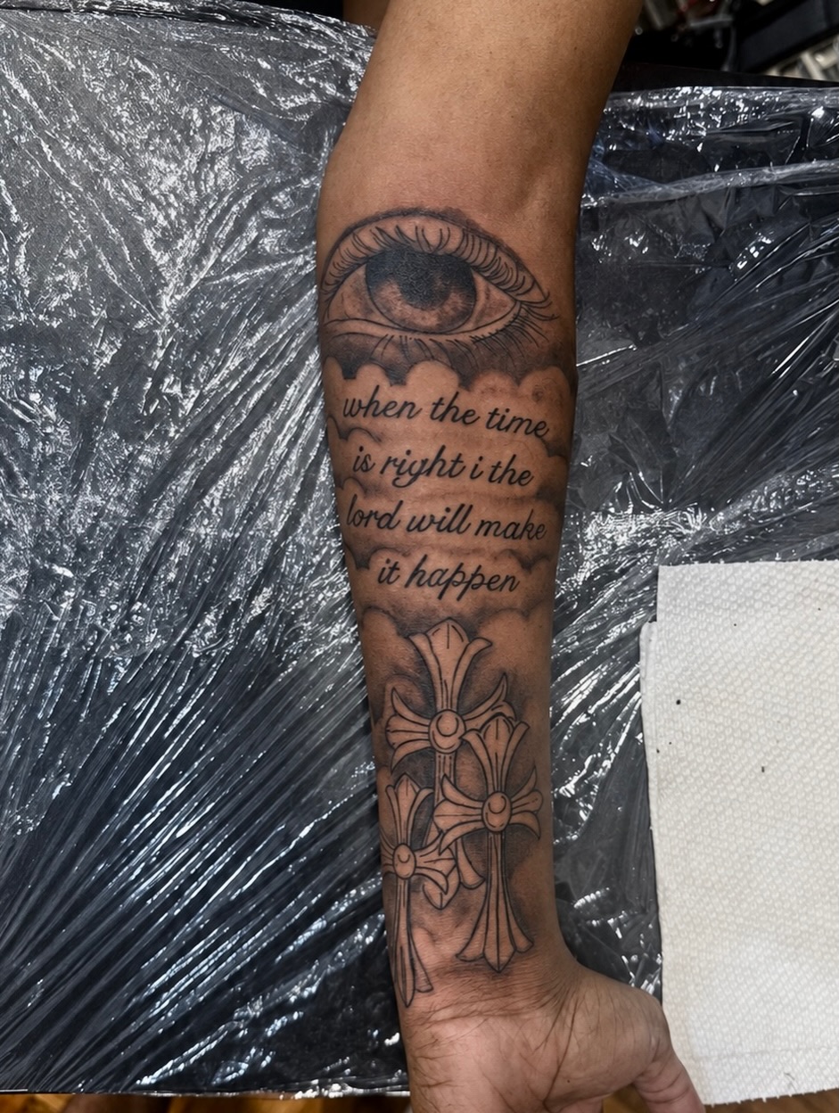 Eye and cross black and grey tattoo on the forearm by JayyeSosa