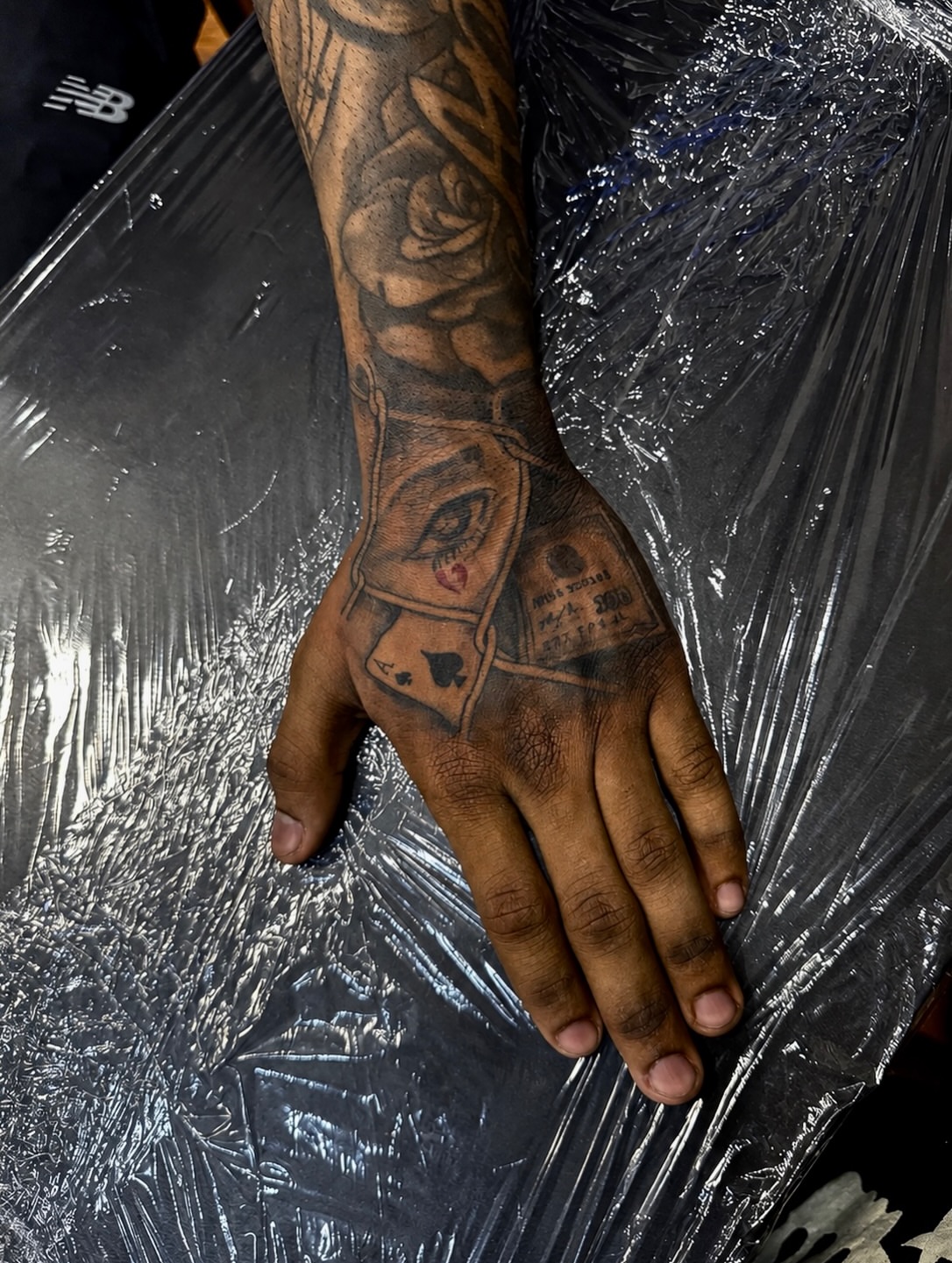 Playing card black and grey tattoo on the hand by JayyeSosa