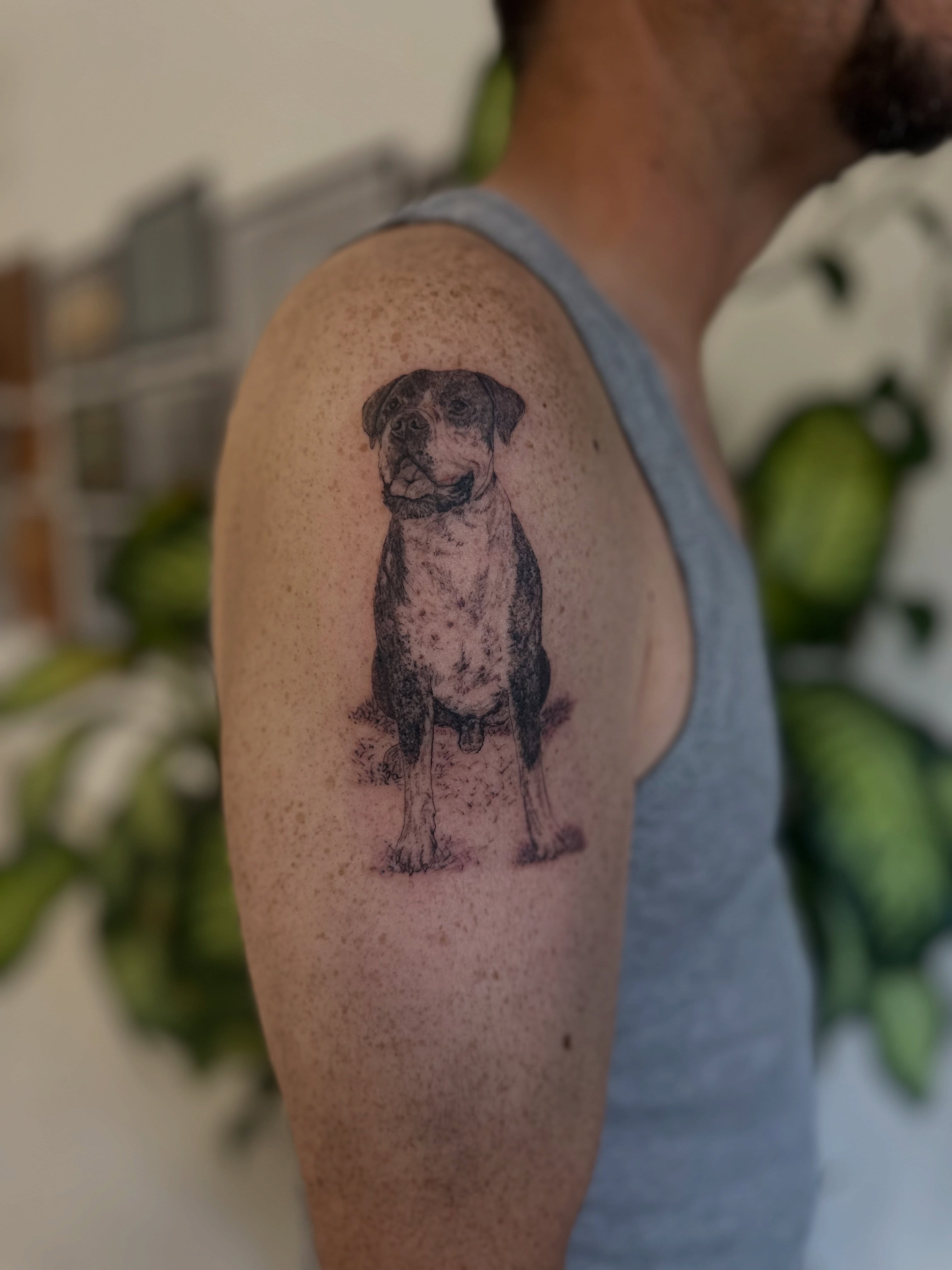 Dog realism tattoo on the upper arm by Ric Castellon Tattoo Artist, Los Angeles, California