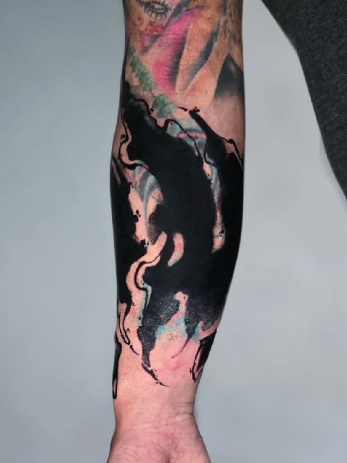 Abstract ink splash watercolor tattoo on the forearm by Ceso732