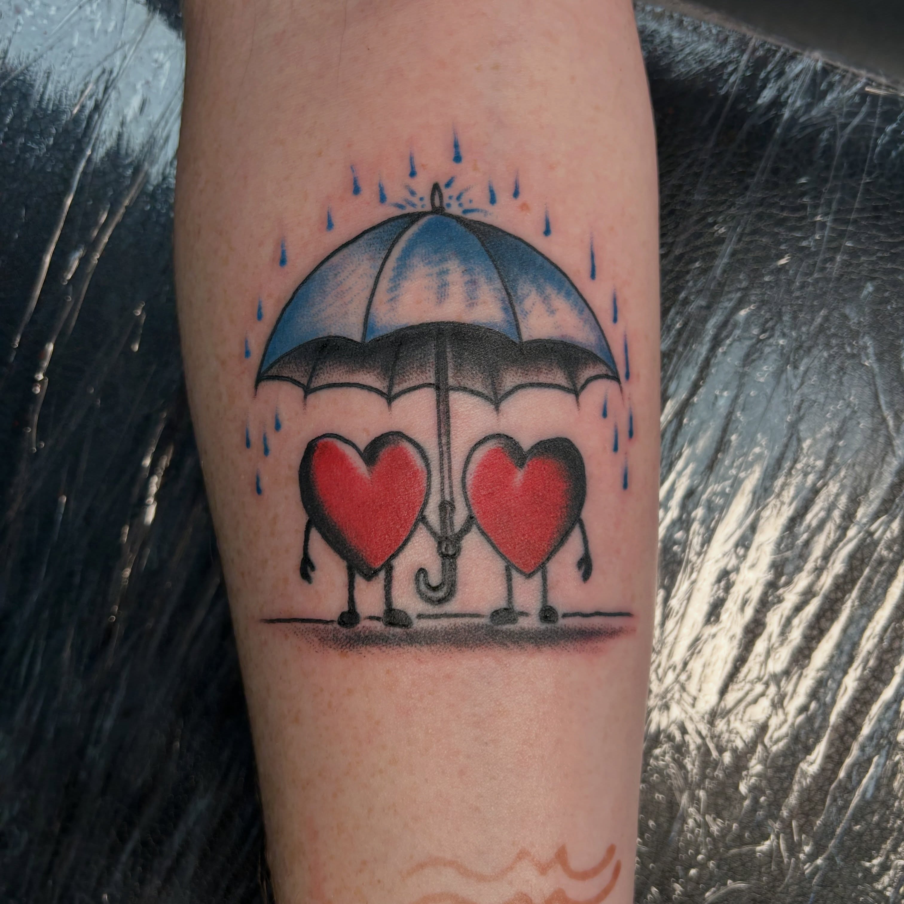 Heart couple under umbrella dotwork tattoo on the forearm by Erik Sacony