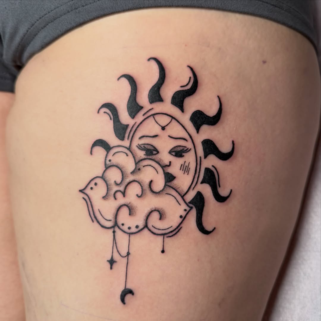 Sun and cloud black and grey tattoo on the thigh by zoie rozay hannah