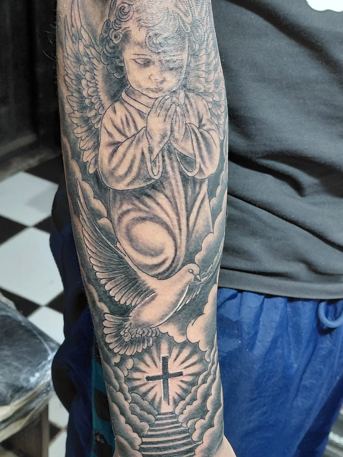 Praying angel realism tattoo on the forearm by Jose Rodriguez