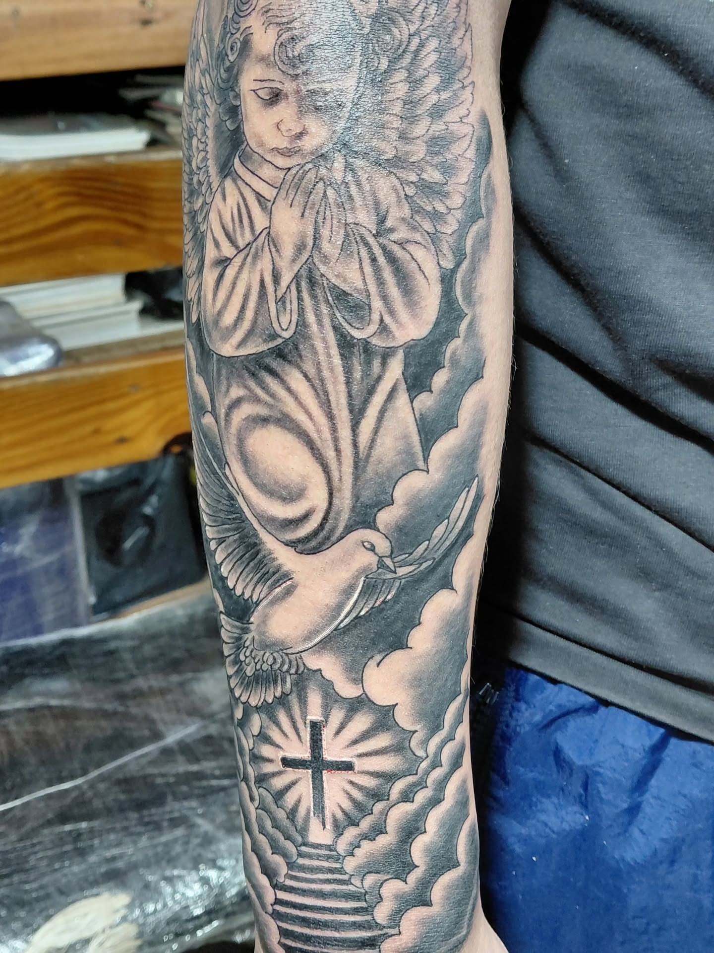 Angel with dove American traditional tattoo on the forearm by Jose Rodriguez
