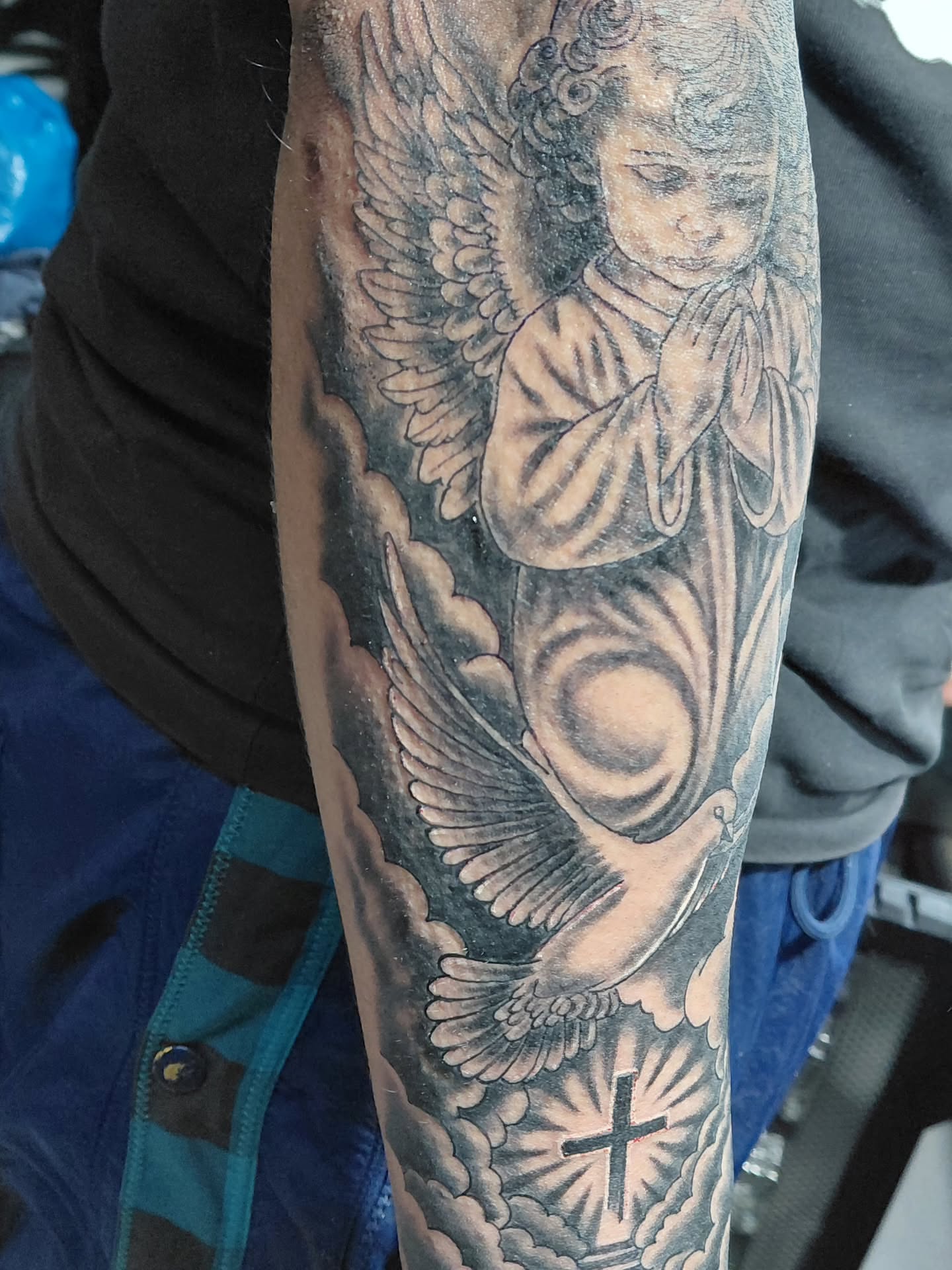Angel praying realism tattoo on the forearm by Jose Rodriguez