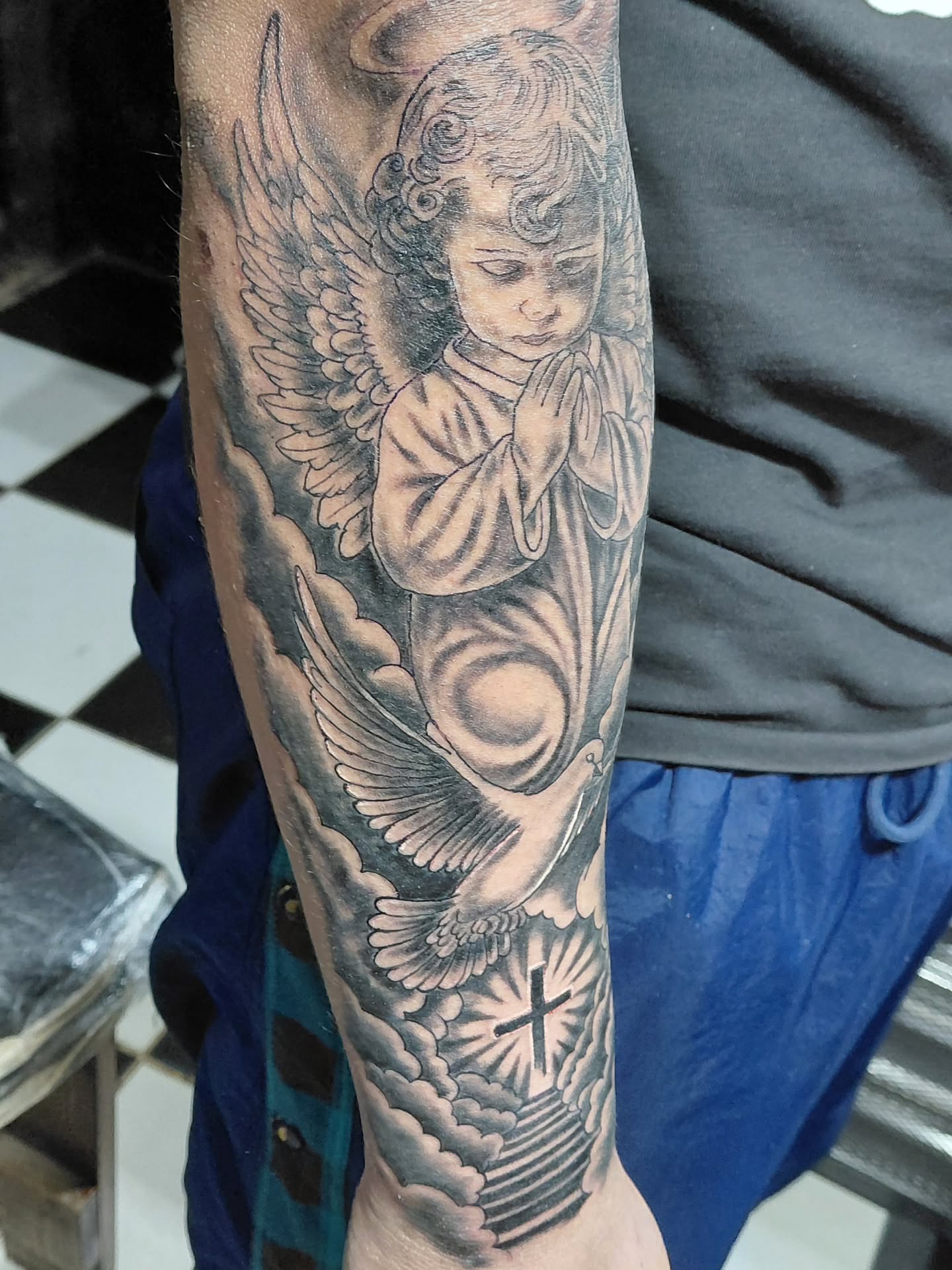 Angel praying realism tattoo on the forearm by Jose Rodriguez