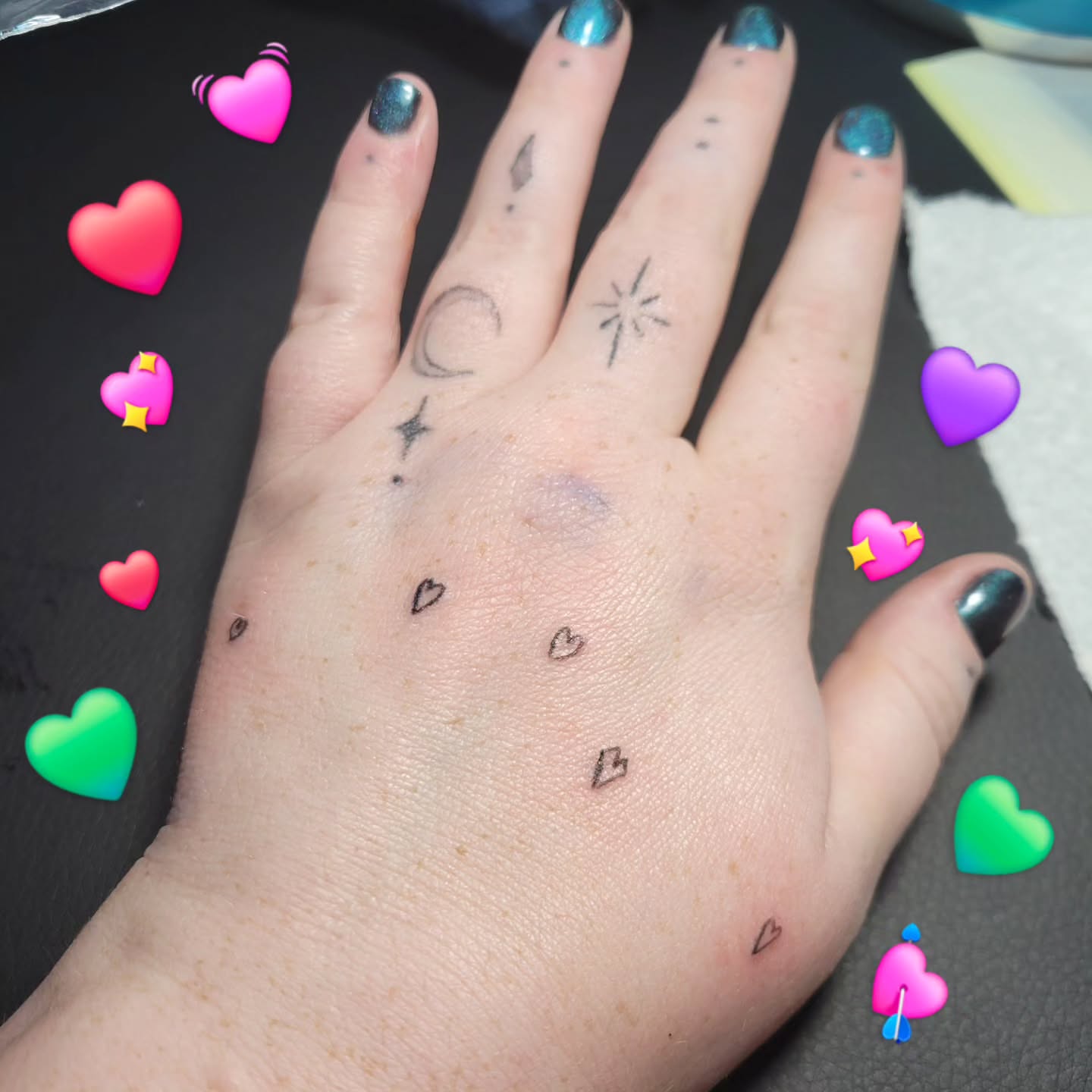 Tiny hearts and stars dotwork tattoo on the hand by Bee