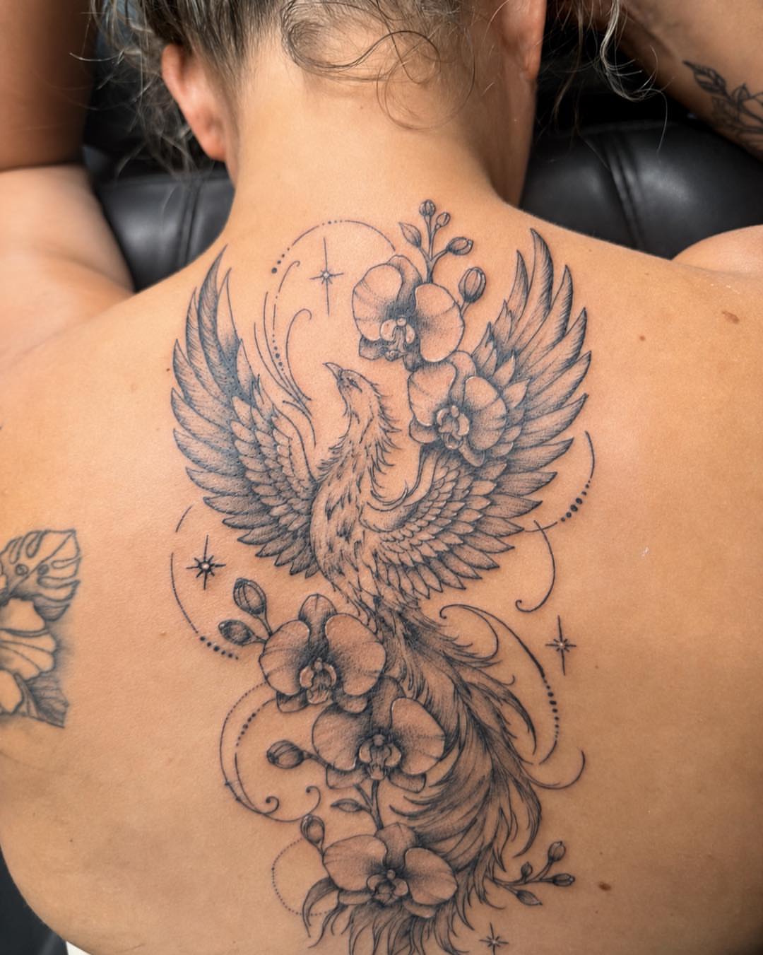 Phoenix and orchids ornamental tattoo on the back by Flamboyant