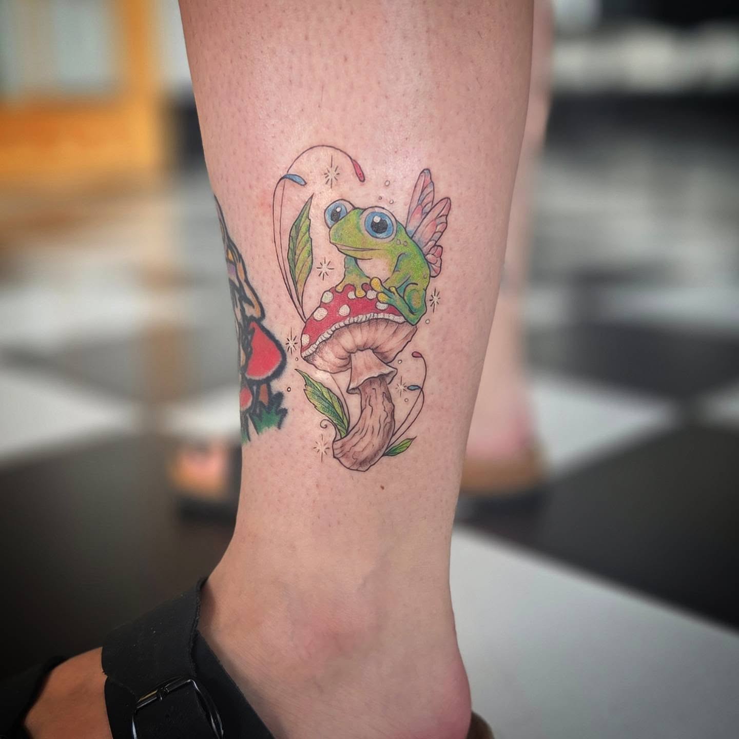 Frog and mushroom new school tattoo on the forearm by Molly DeSmedt