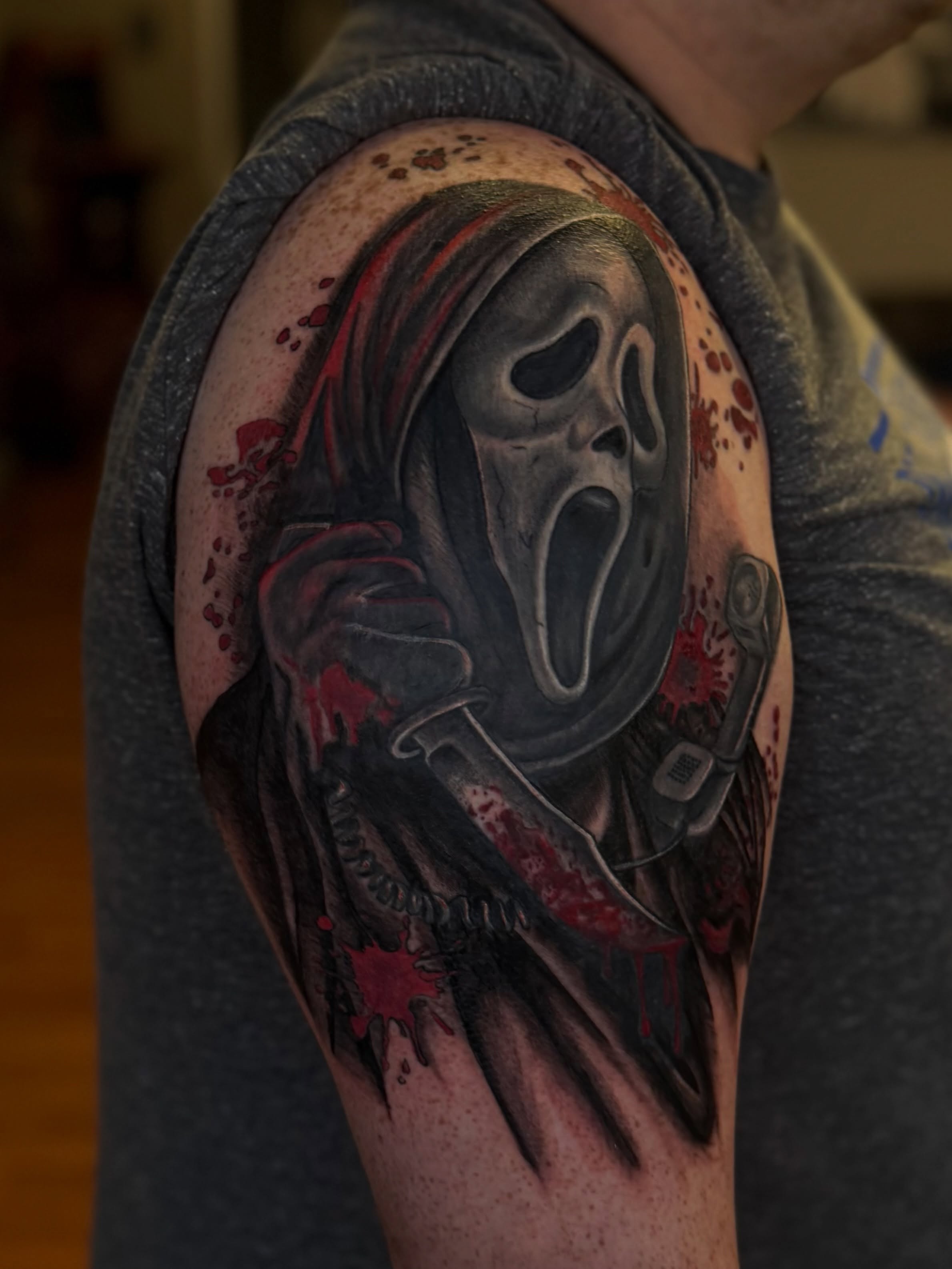 Scream mask realism tattoo on the shoulder by Skylar Sheeley