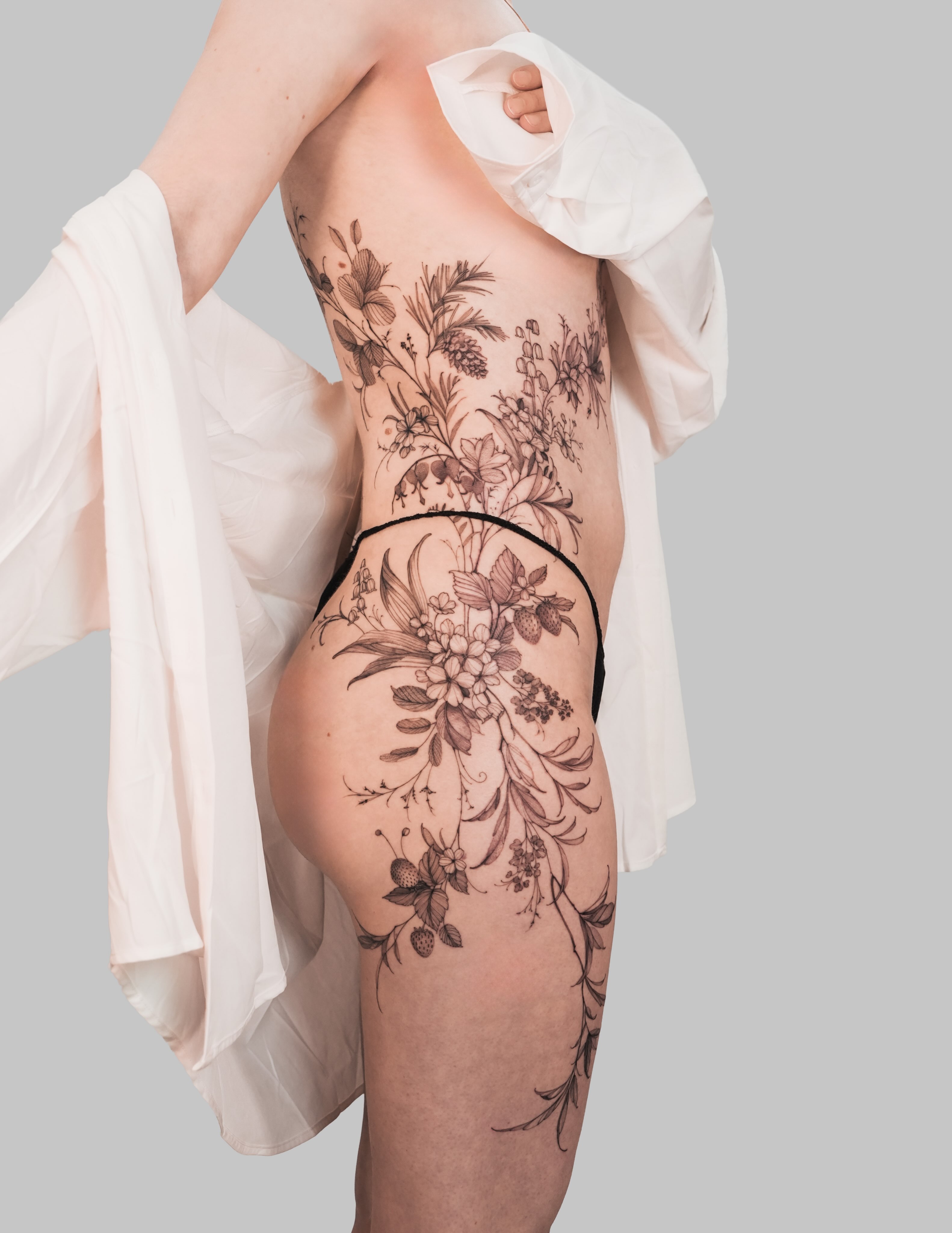 Floral black and grey tattoo on the torso by Yuliia Babych tattoo AUSTIN
