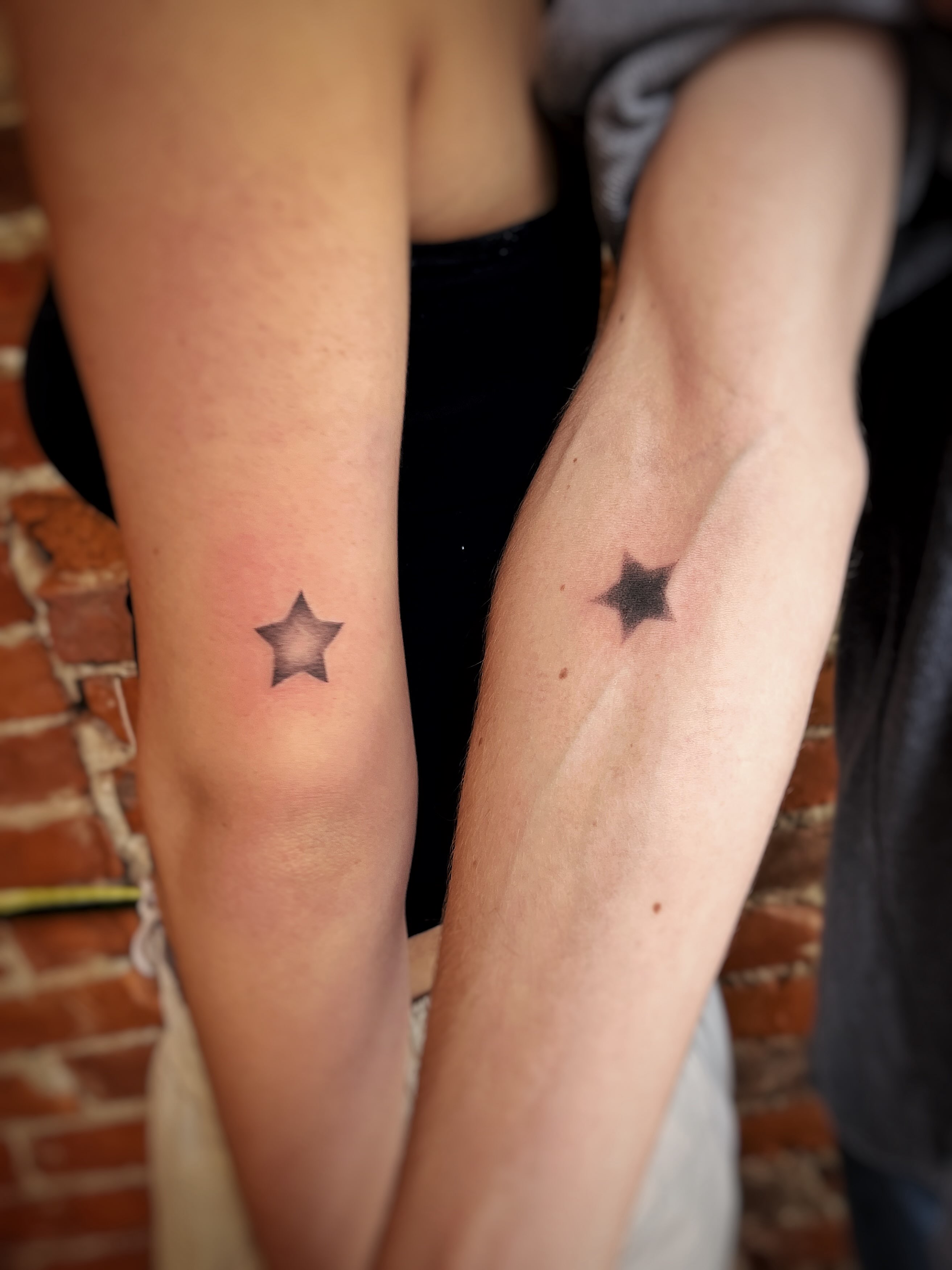 Star black and grey tattoo on the forearm by Risa Cincinnati Tattoo Artist