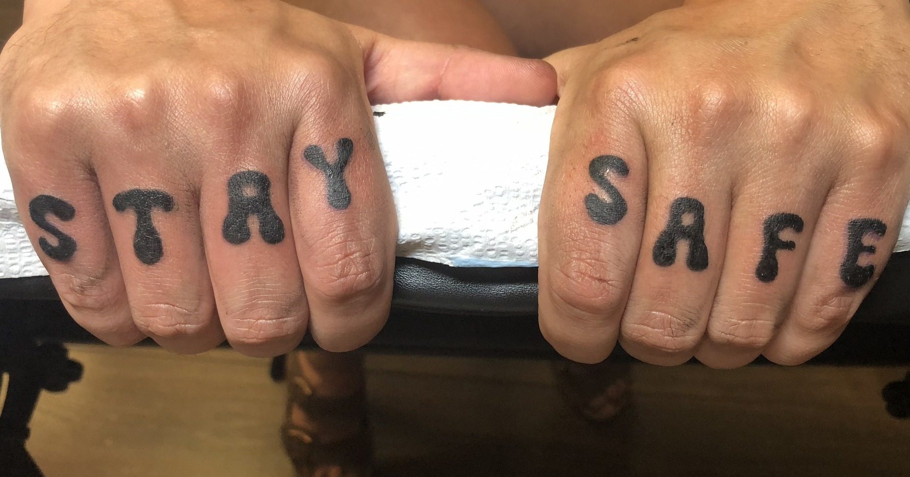 Stay safe lettering script tattoo on the hand by Rowan Lee
