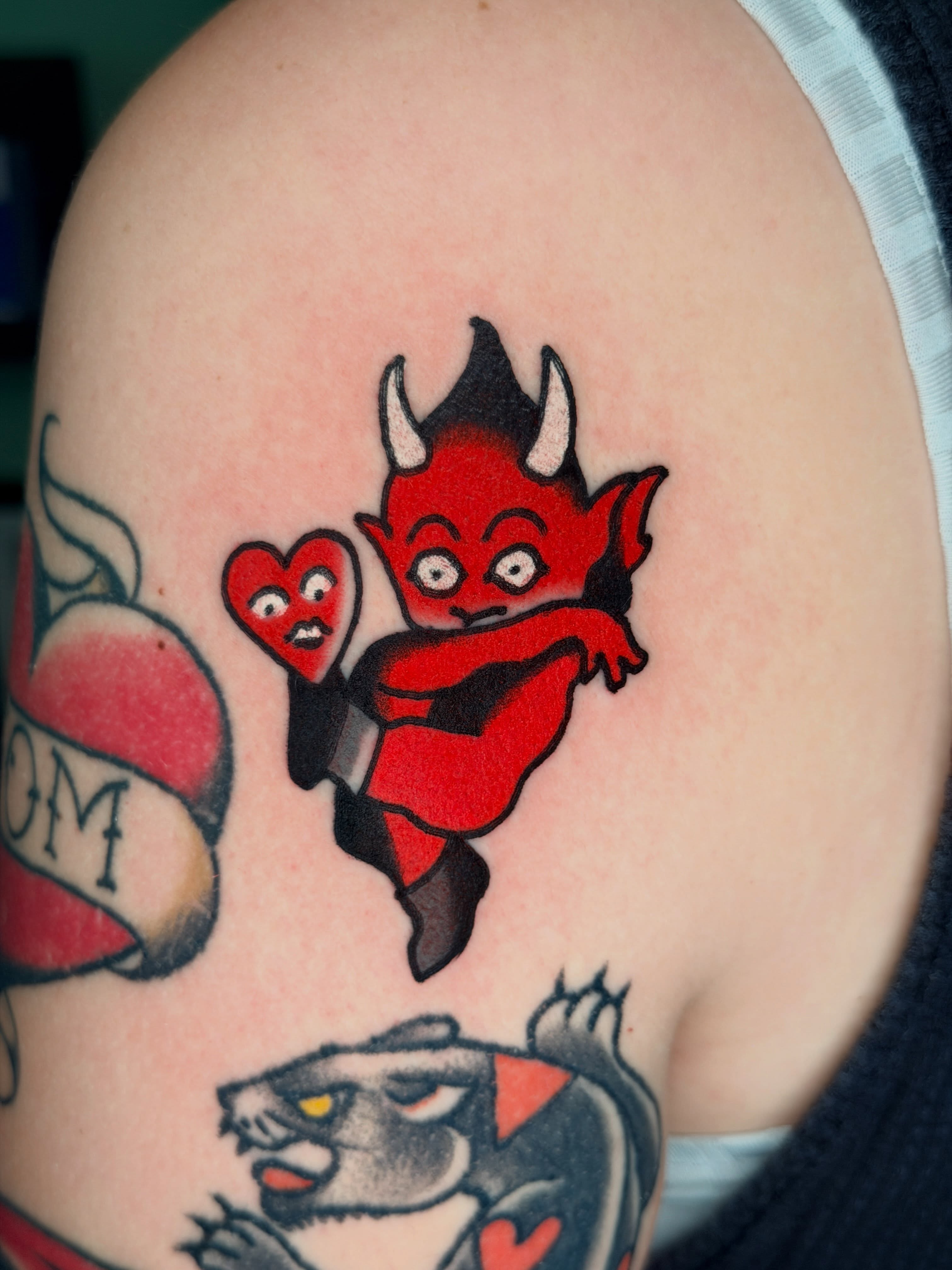 Devil holding heart American traditional tattoo on the shoulder by ๐๐ซ๐ข๐ ๐๐ฅ๐ญ๐จ๐ง๐๐ง
