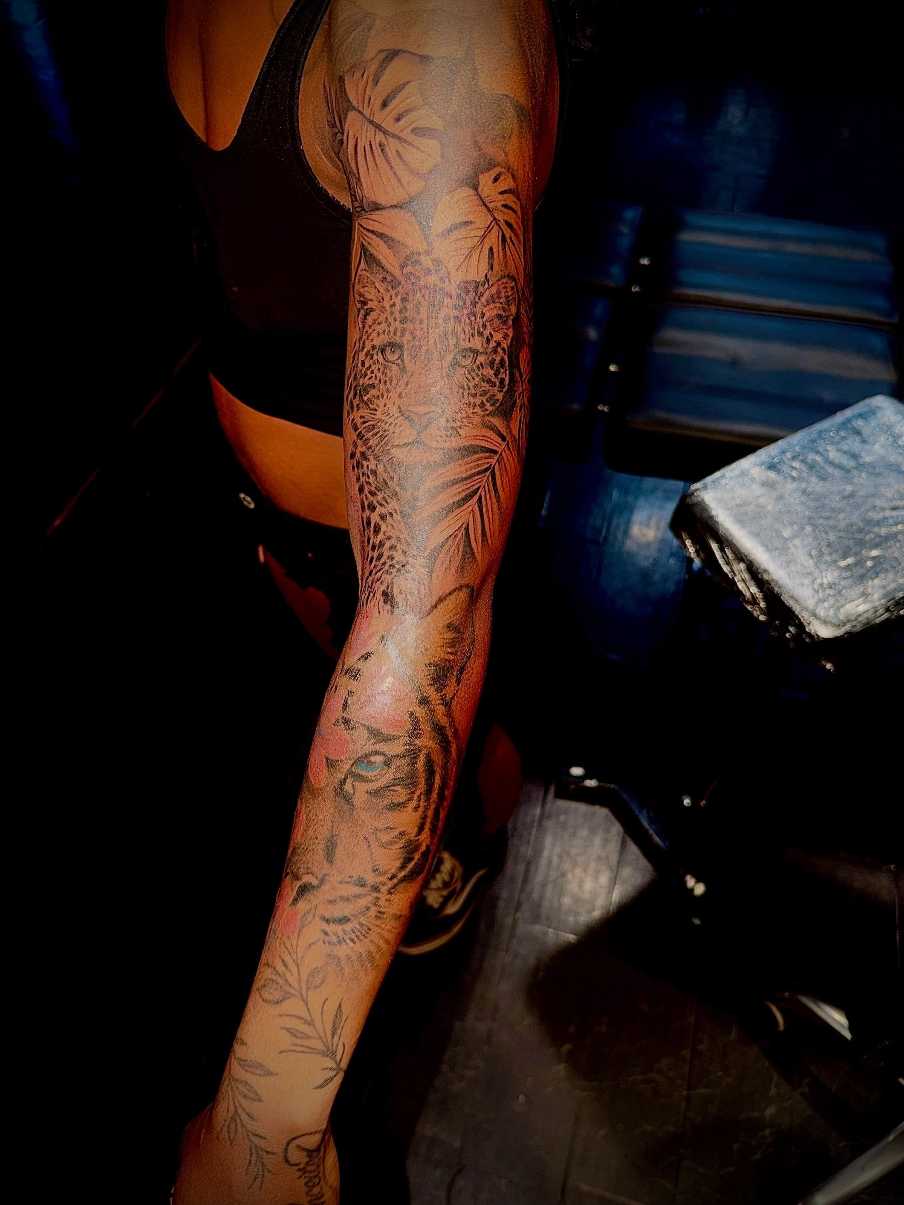Jungle animals realism tattoo on the forearm by Clifford Jordan