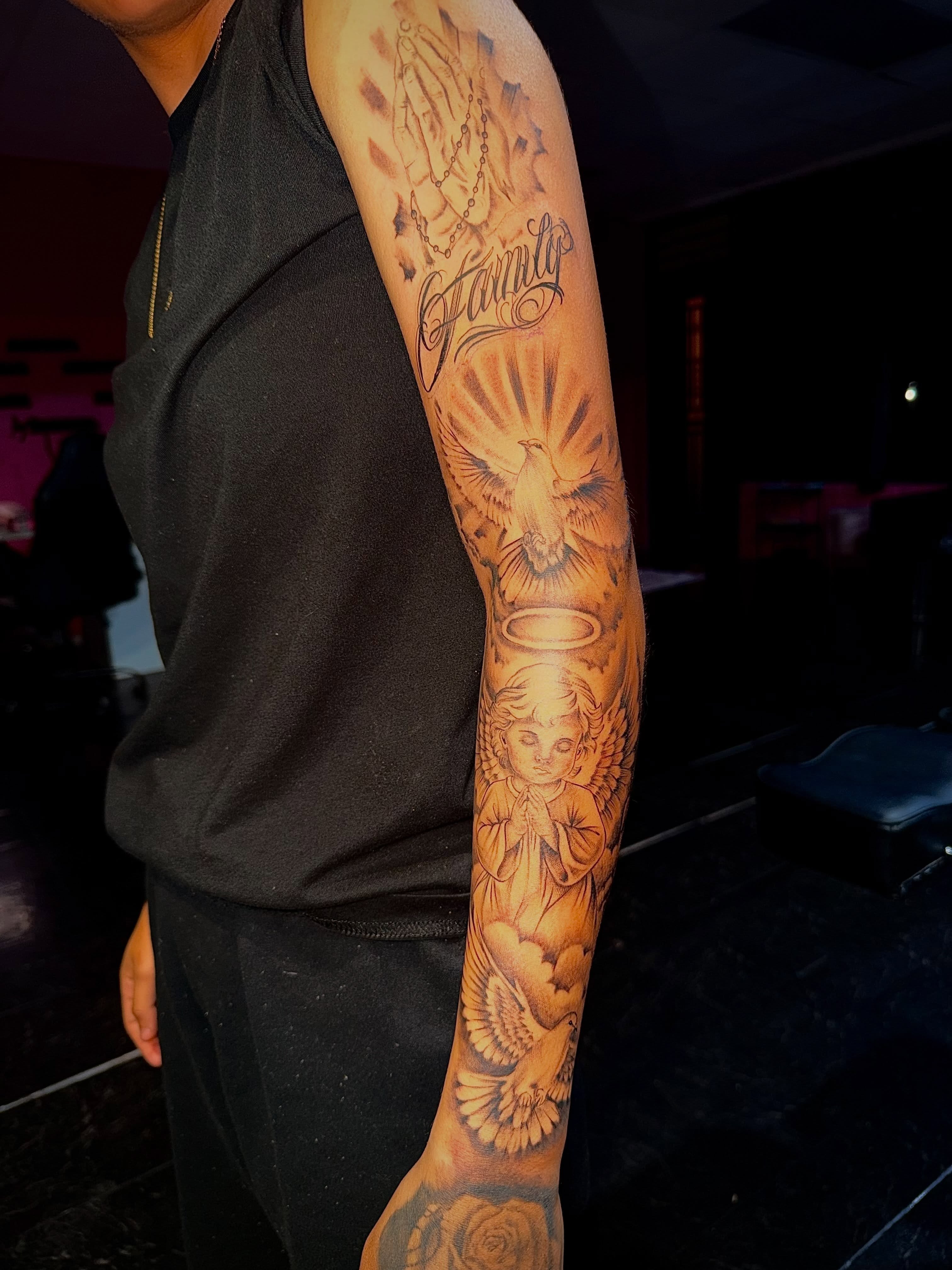 Prayer hands and dove realism tattoo on the forearm by Clifford Jordan