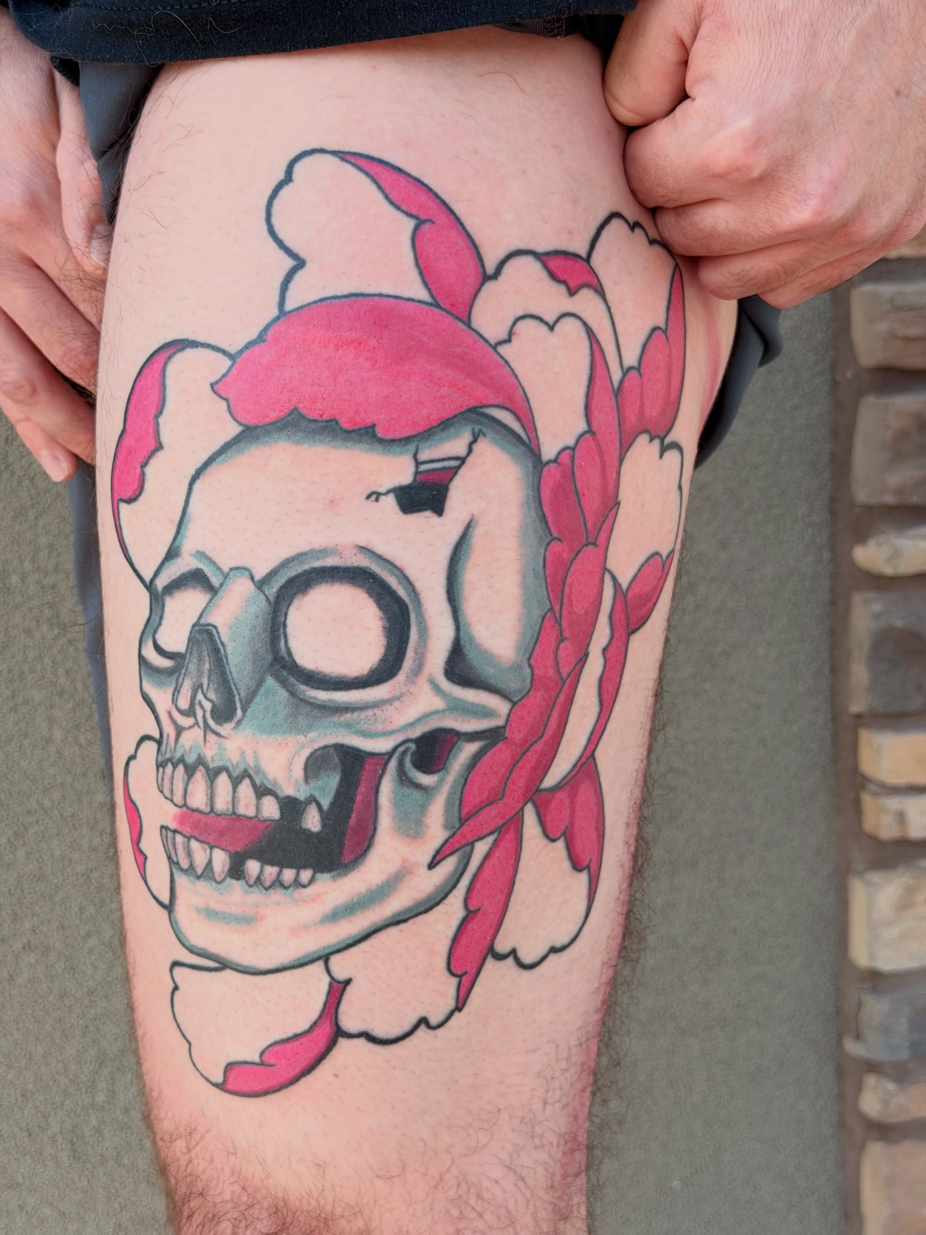 Skull with pink bandana American traditional tattoo on the thigh by Ellari