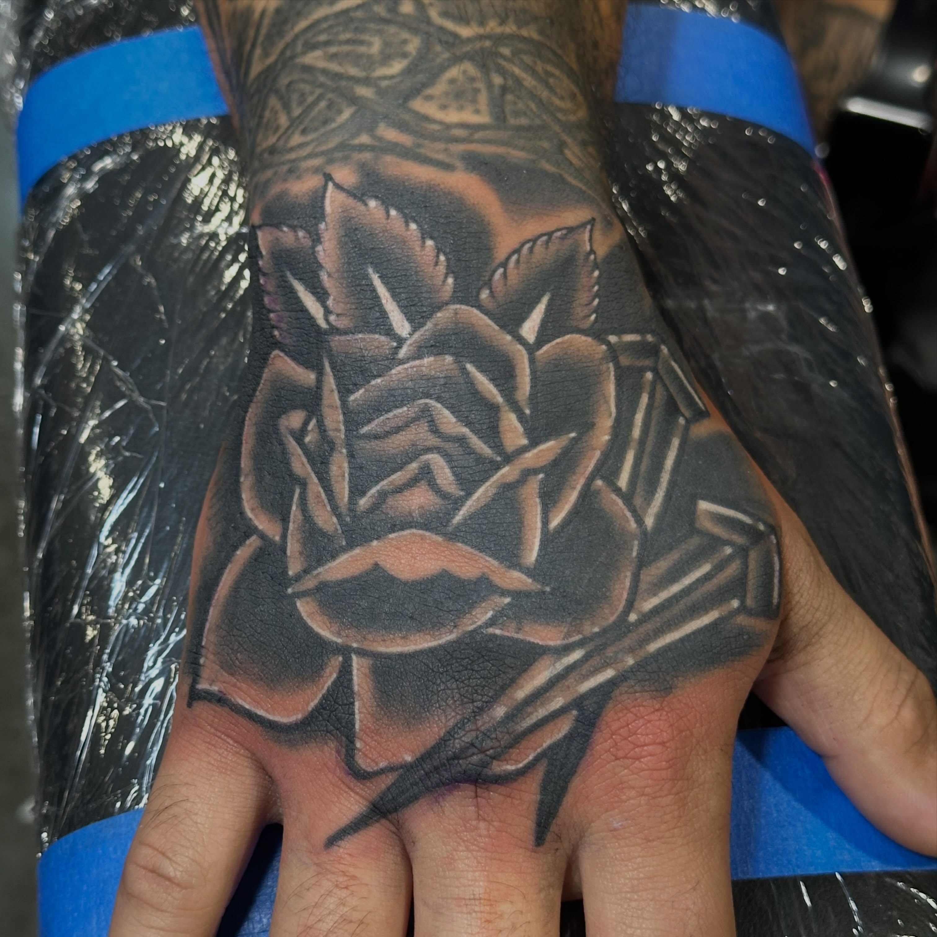 Rose black and grey tattoo on the hand by Wesley Lam