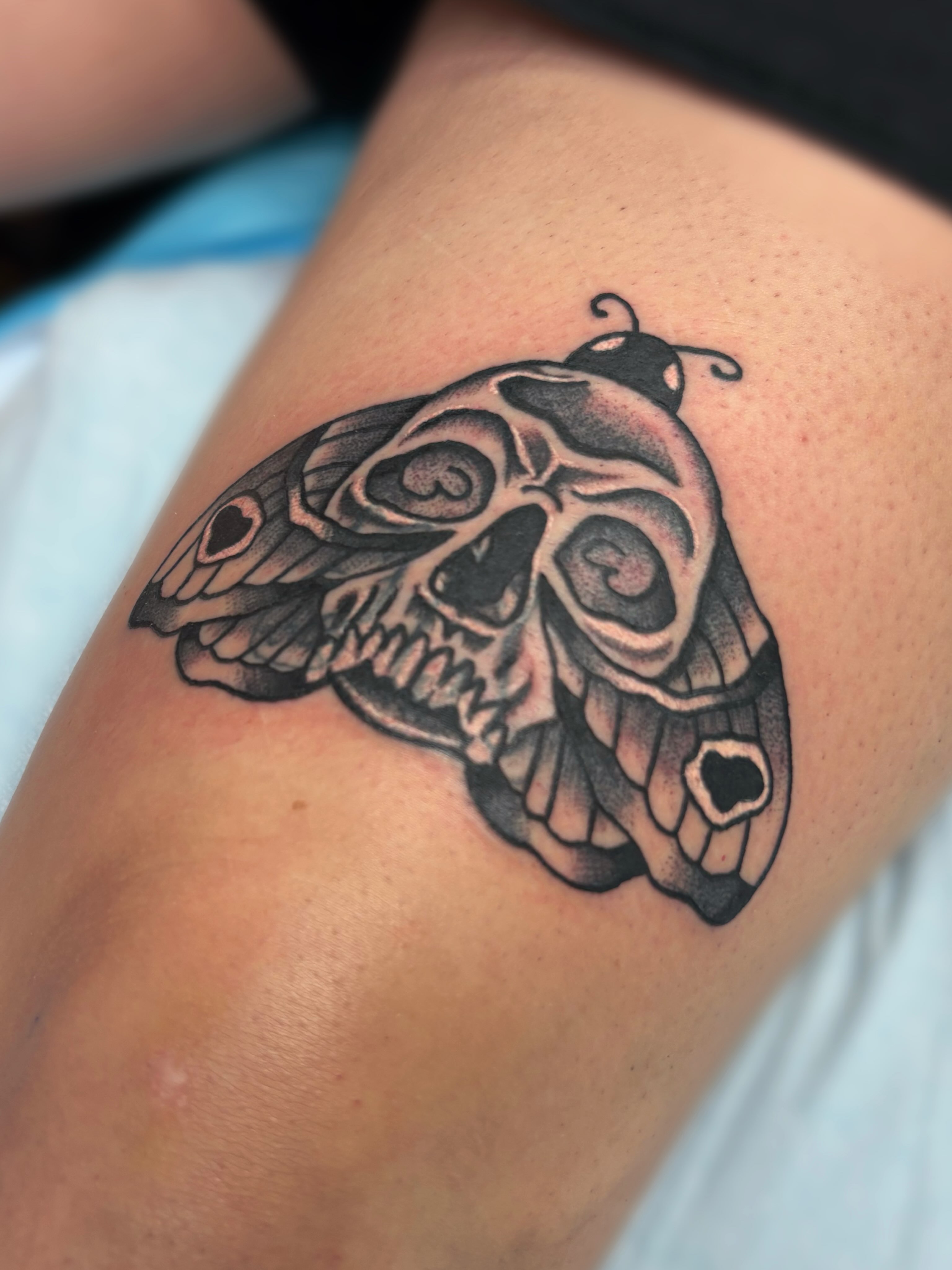 Skull black and grey tattoo on the thigh by Ava Brady Tattoos