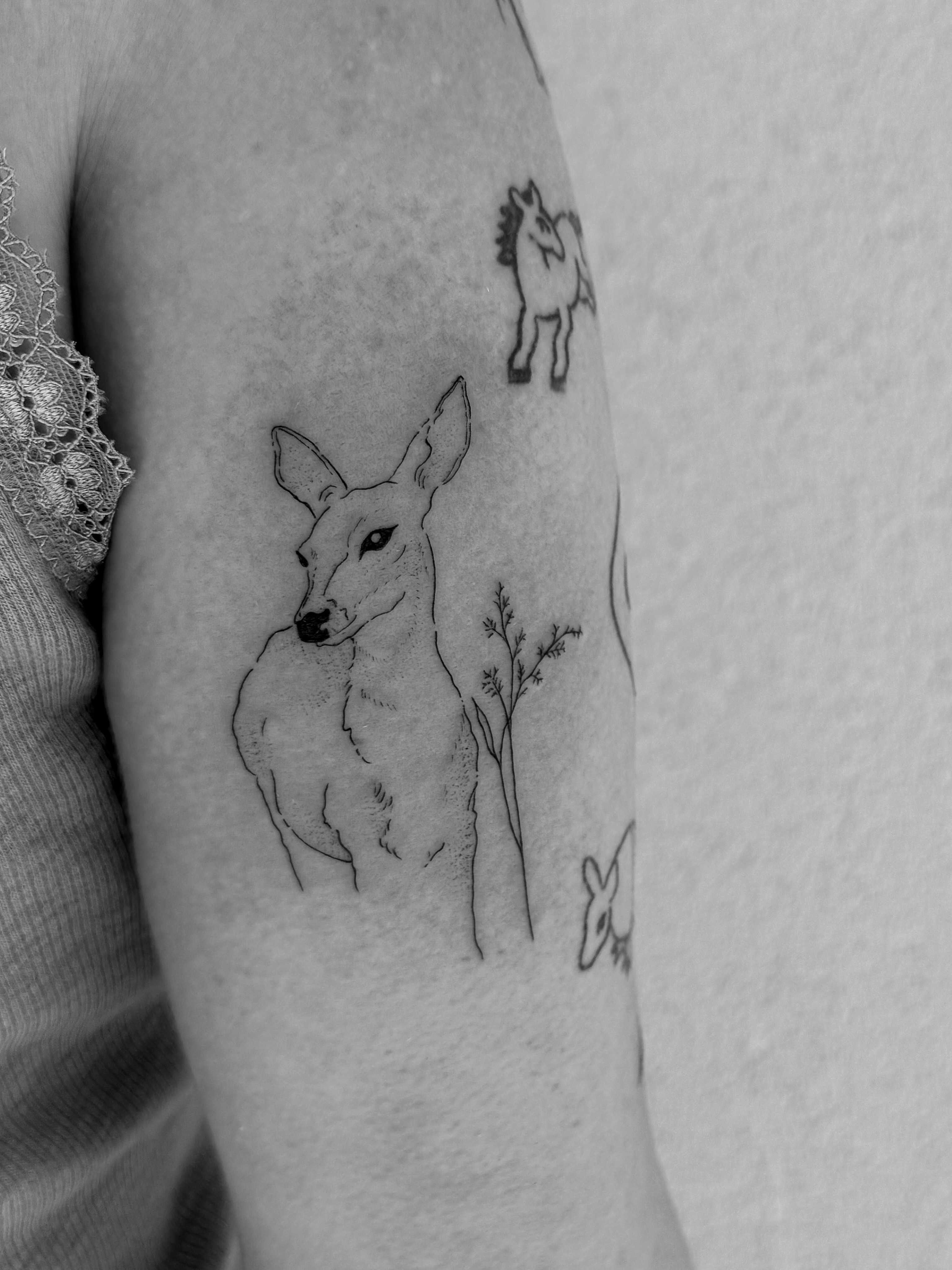 Deer black and grey tattoo on the forearm by Abby Robinson