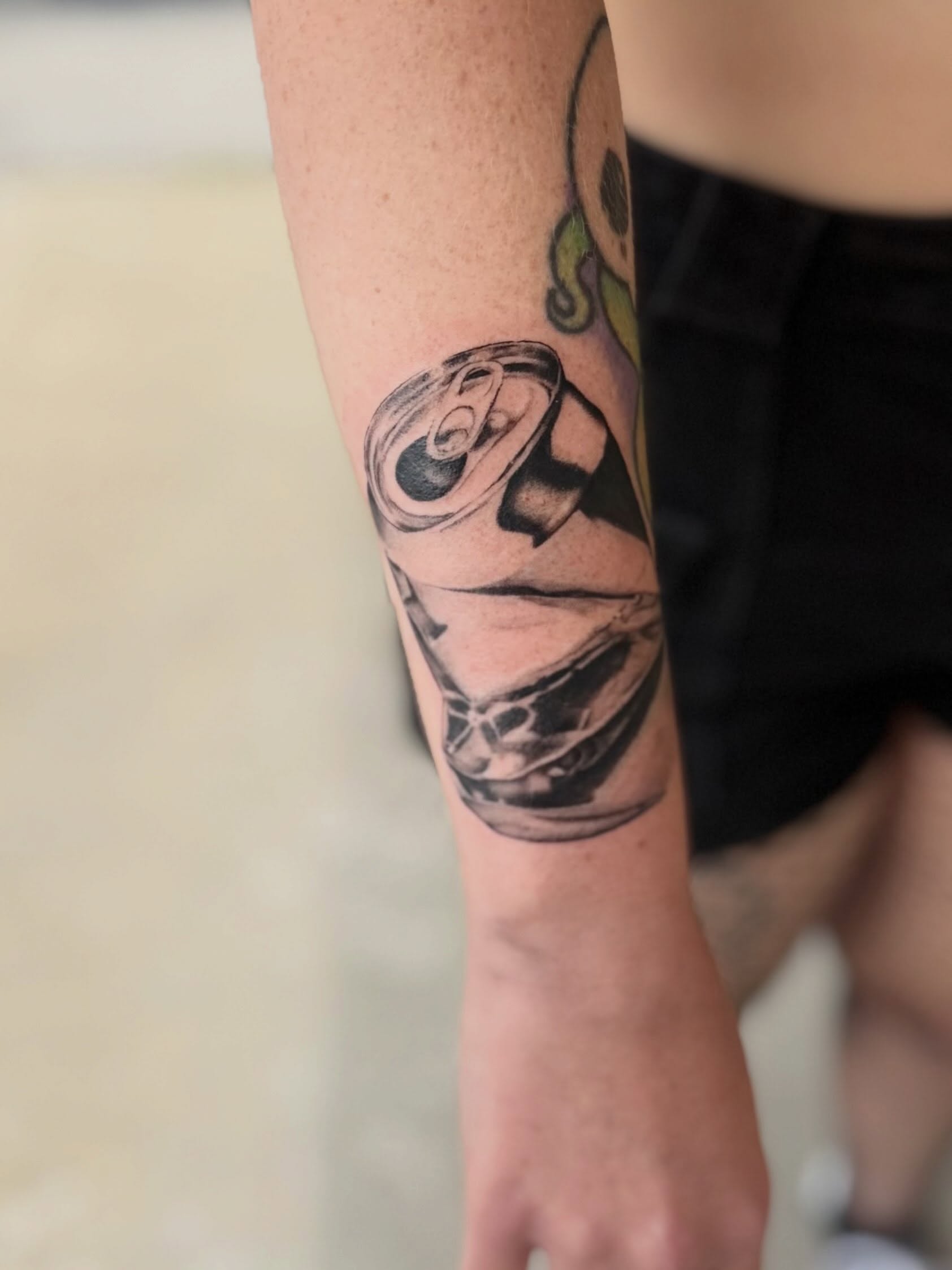 Can black and grey tattoo on the forearm by Rebecca (Becca) Ray