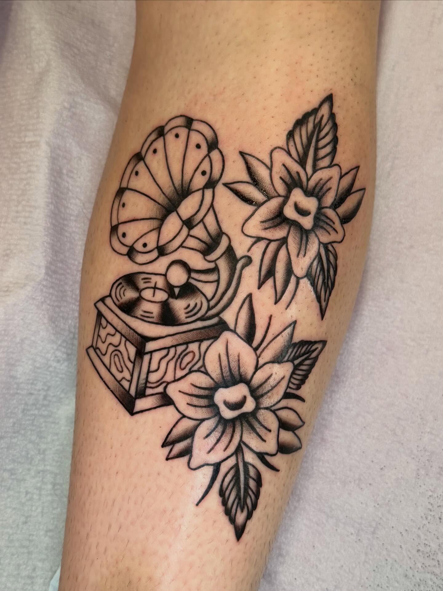 Gramophone and flowers American traditional tattoo on the forearm by charlie