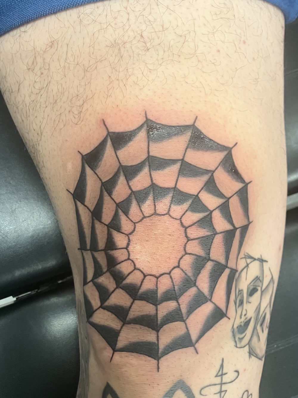 Spider web geometric tattoo on the thigh by Bryant Johnson