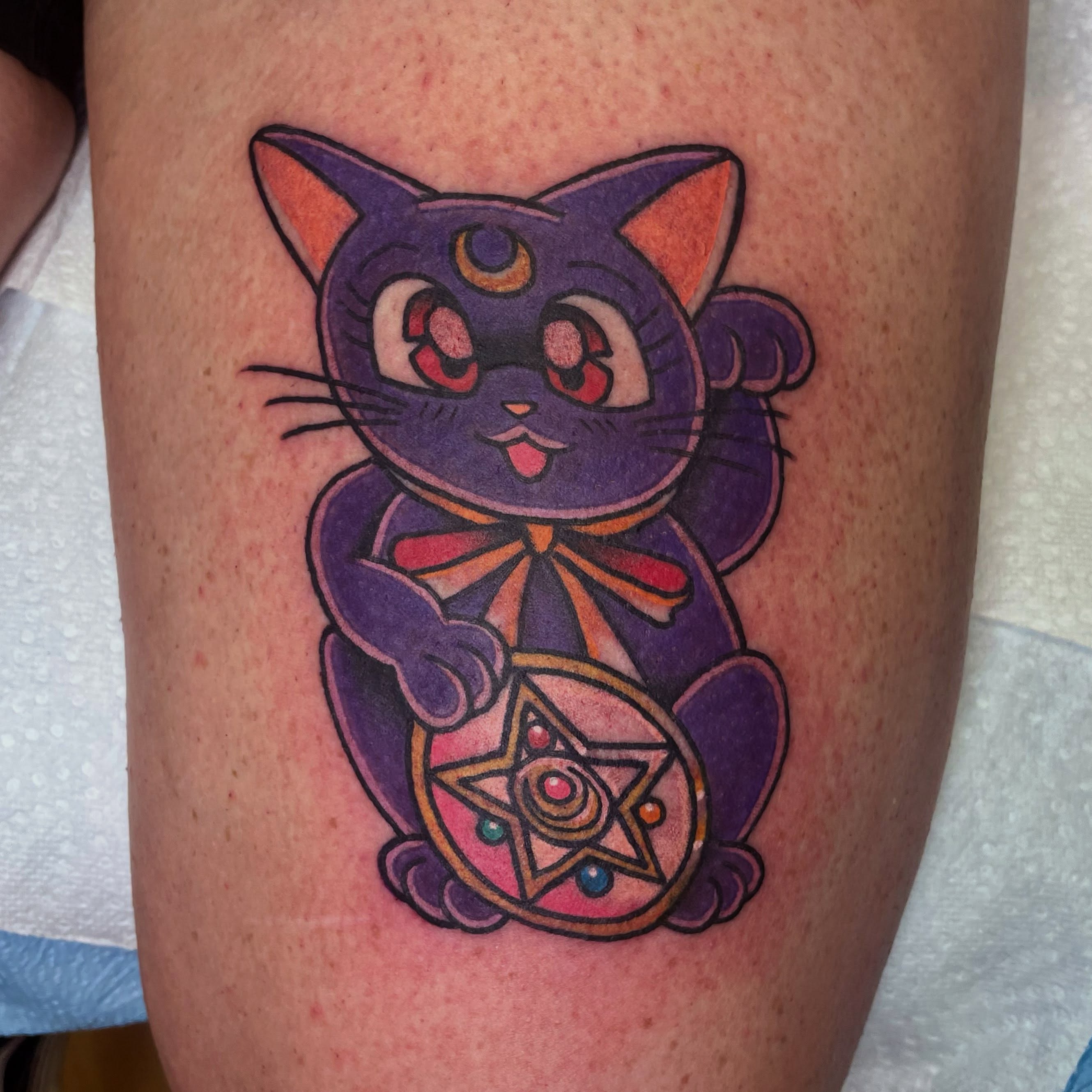 Cat anime tattoo on the thigh by Robert Morrow