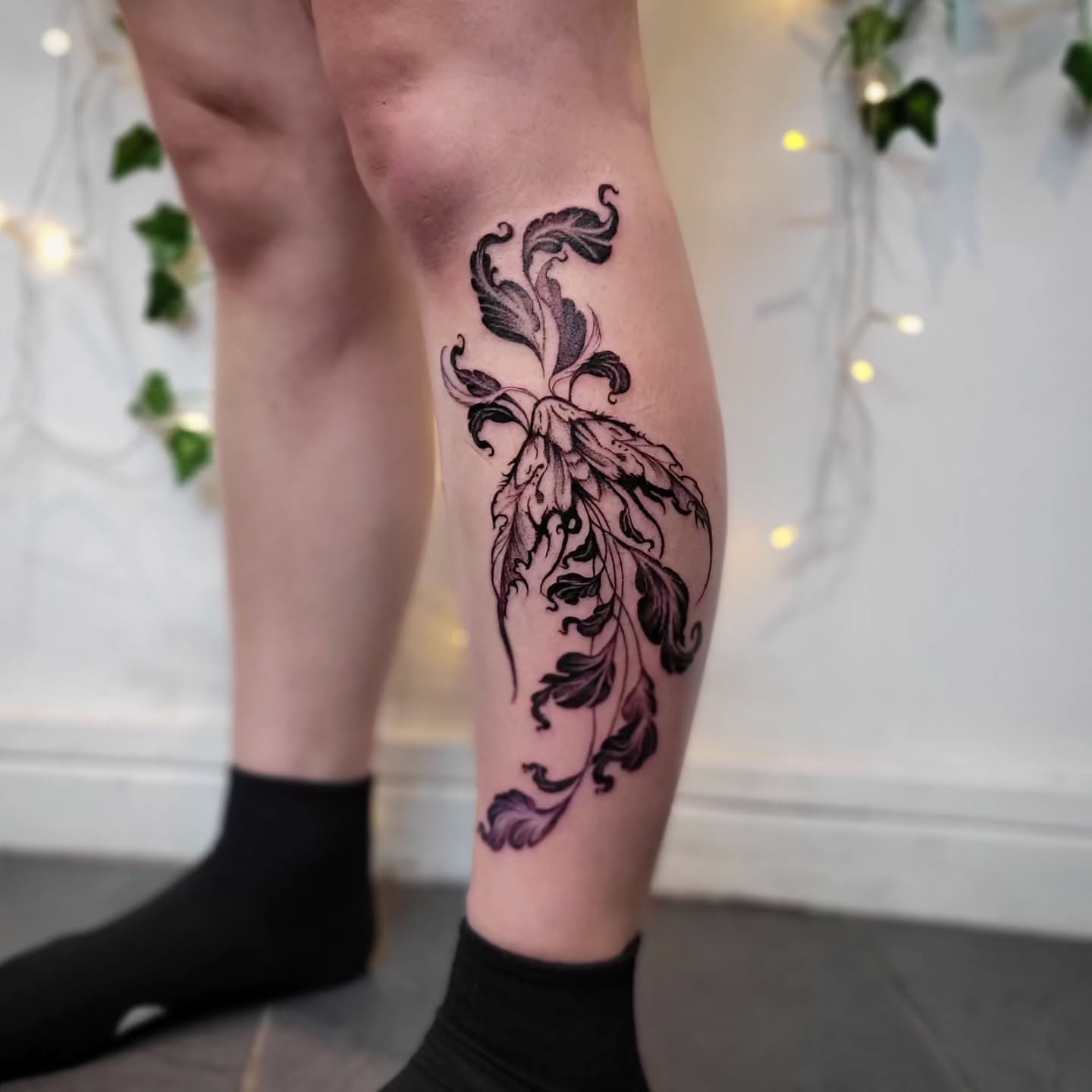 Floral design ornamental tattoo on the calf by Uku Tattoos, Cambridge, England