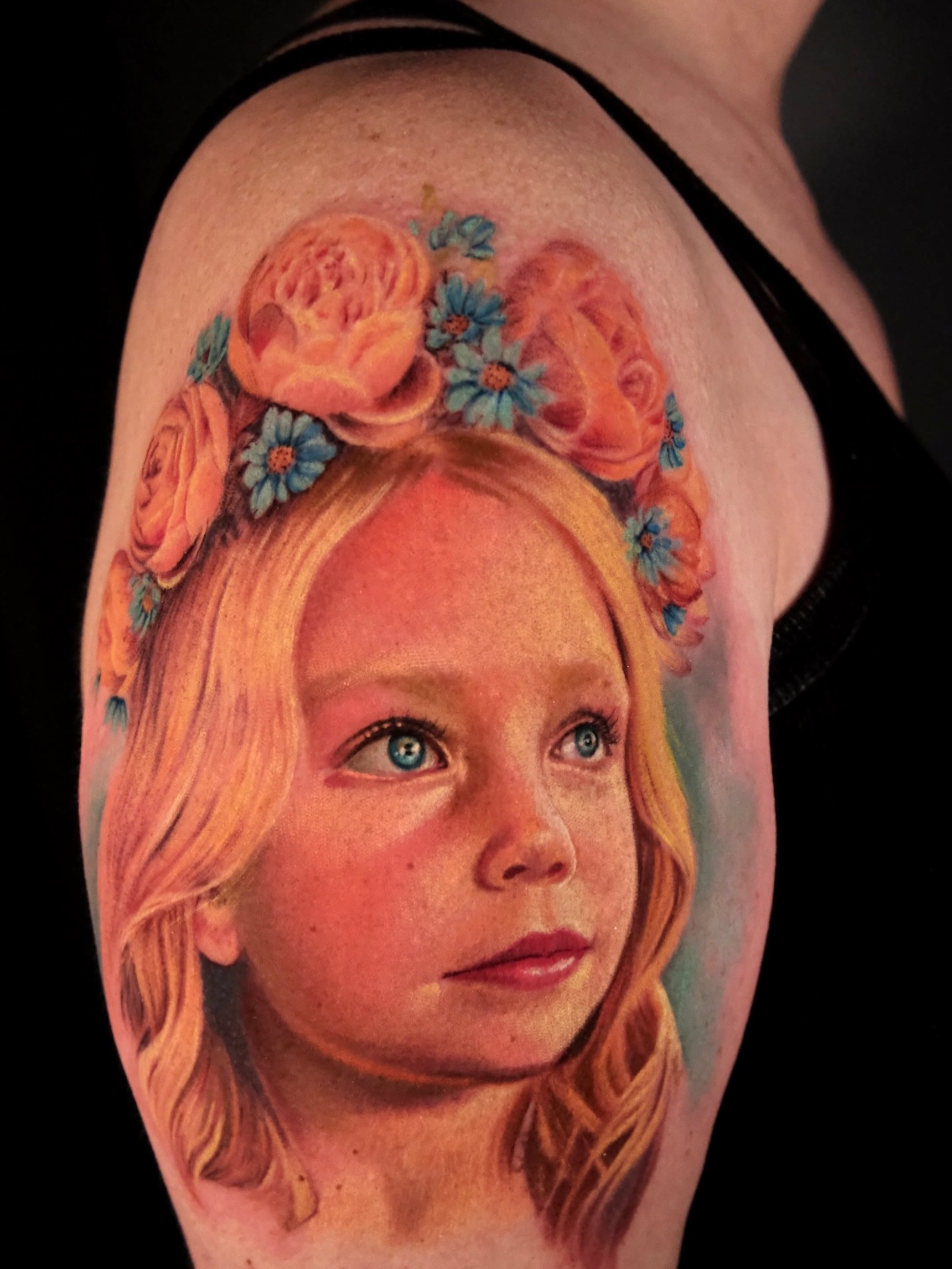 Child's face with floral crown realism tattoo on the shoulder by AL 777, Denton, Texas