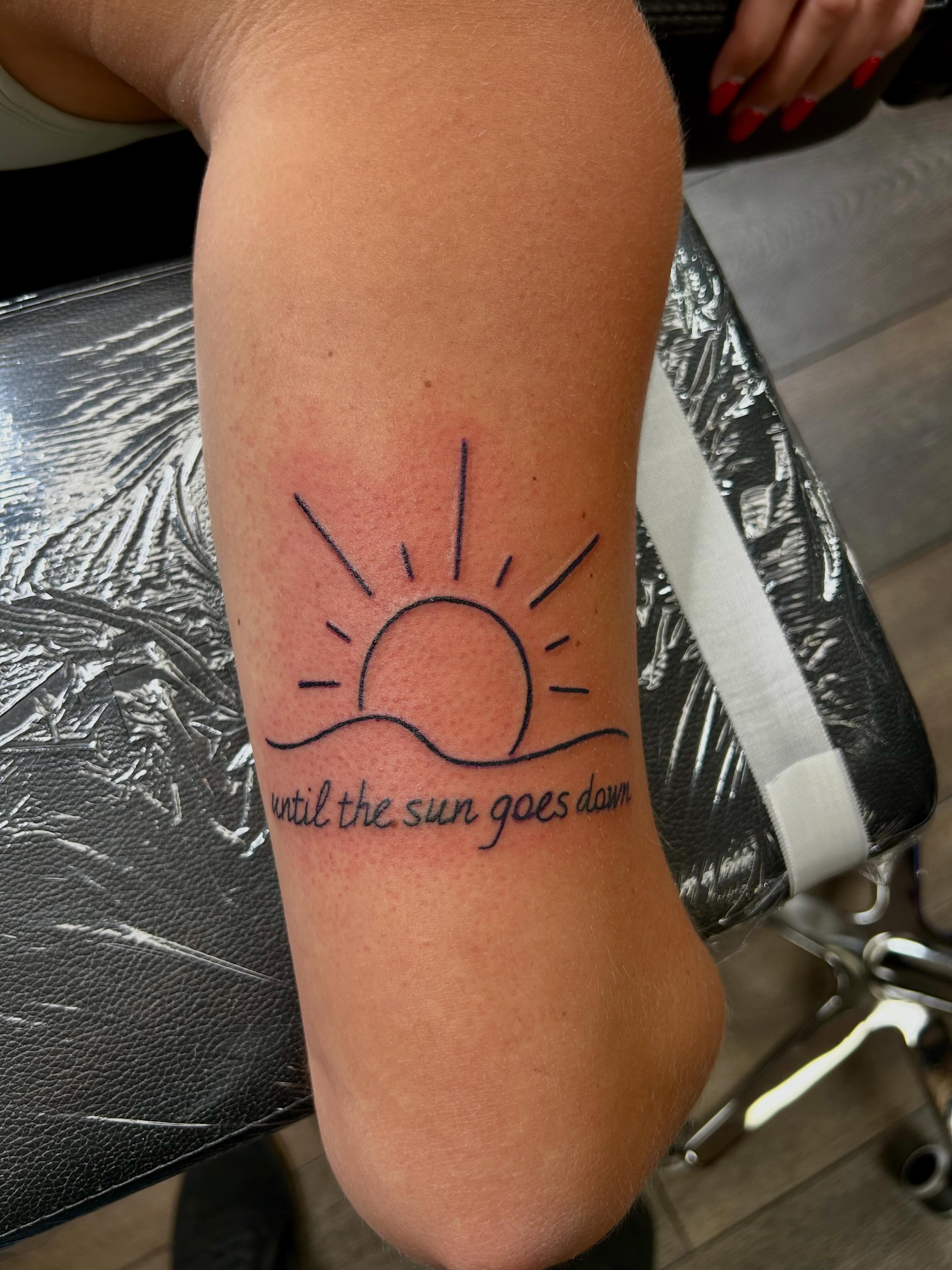 Sun and wave minimalist tattoo on the forearm by Bjorn Bjornstad, Dubuque, Iowa