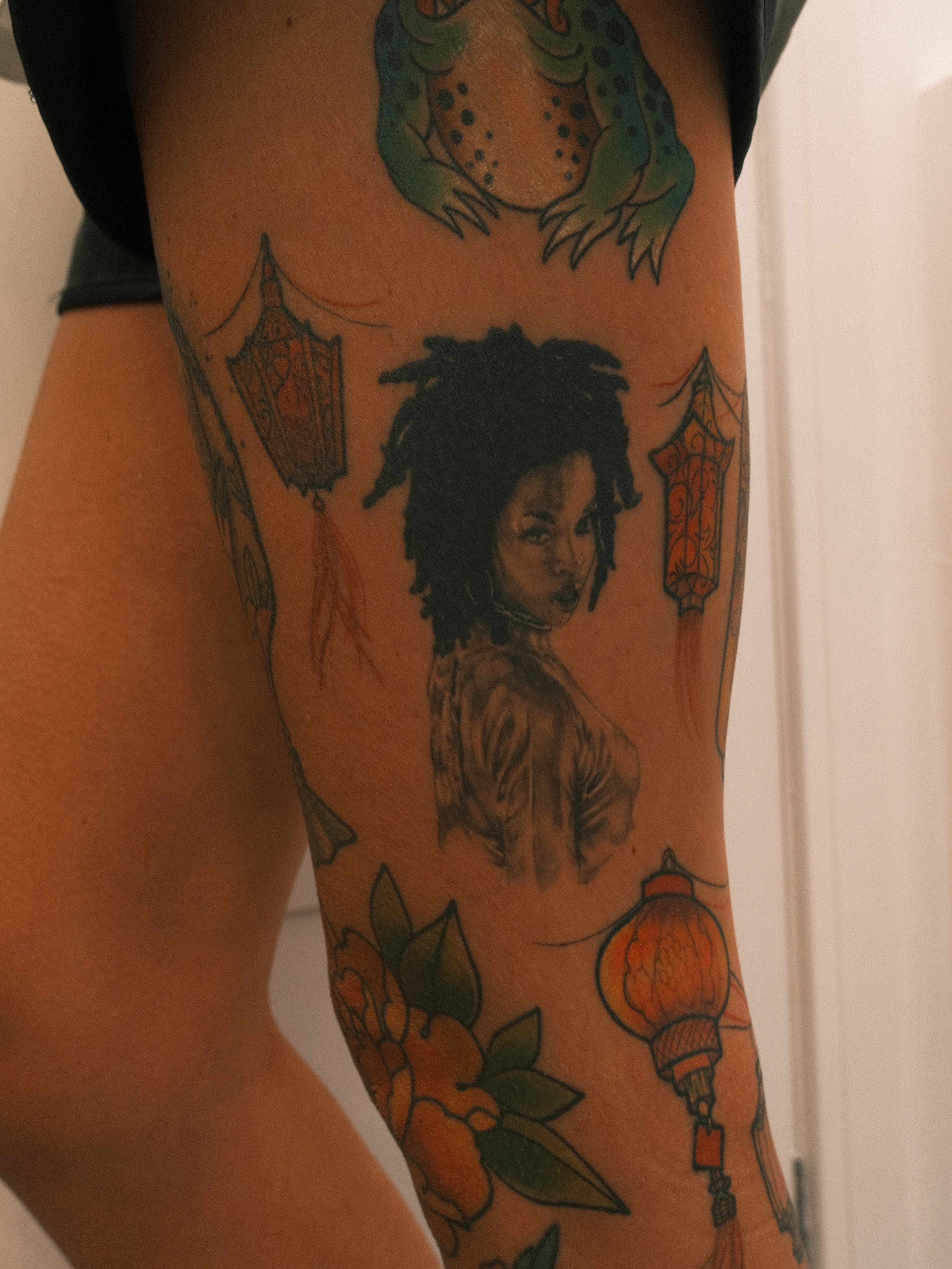 Woman with dreadlocks realism tattoo on the thigh by Ross Clark Tattoos