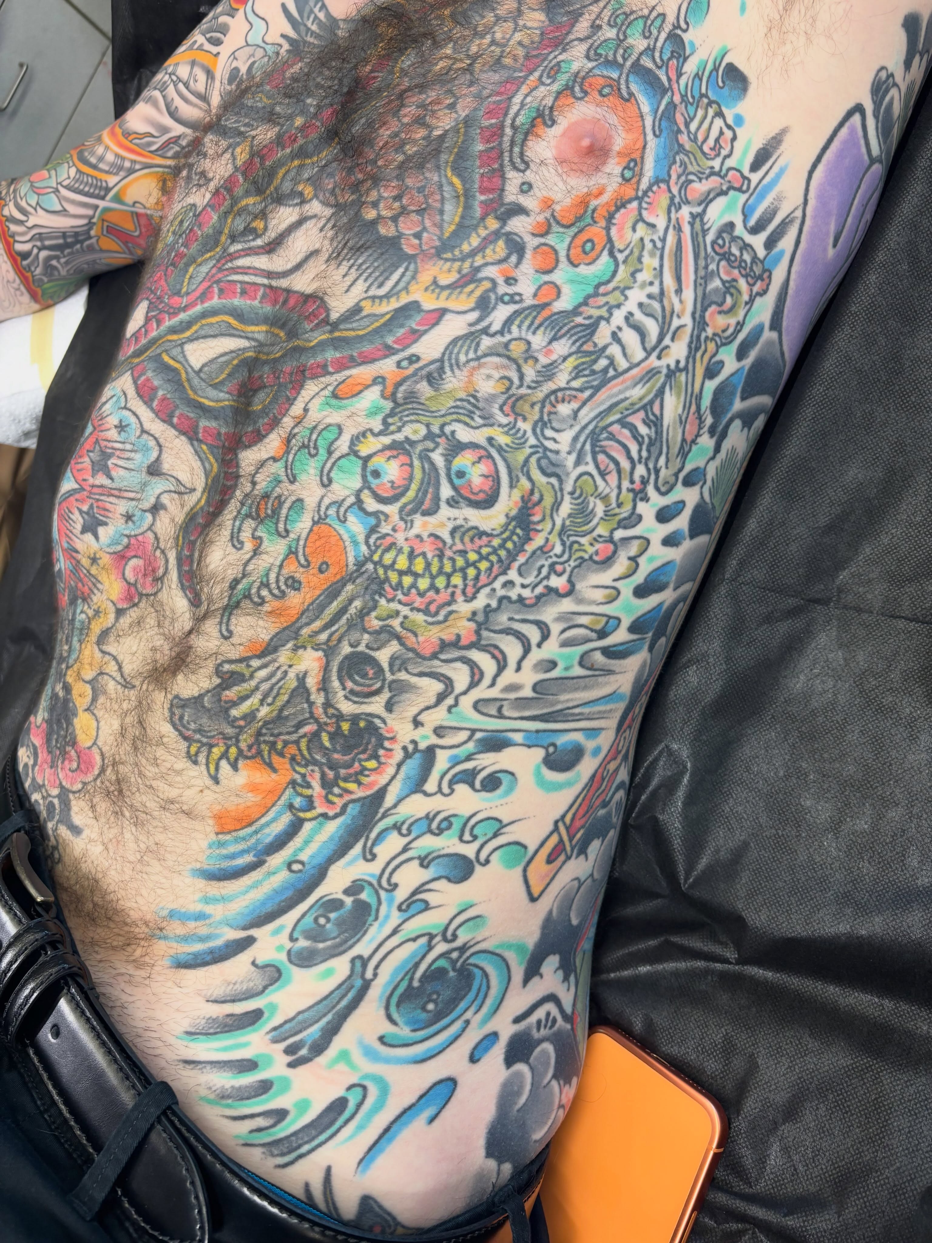 Skull and waves American traditional tattoo on the thigh by Tim Lehi, Oakland, California
