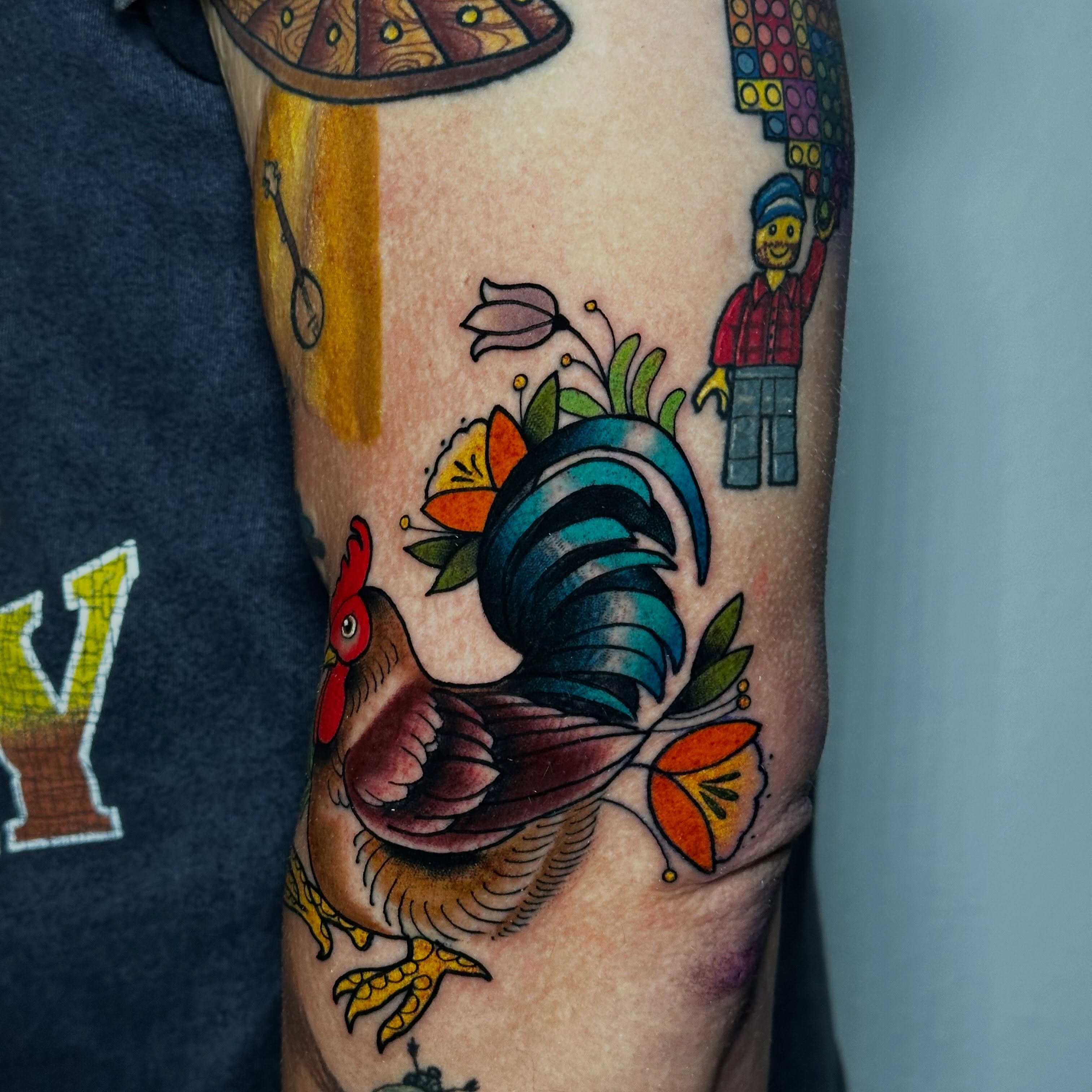 Rooster American traditional tattoo on the forearm by Liz McDonald