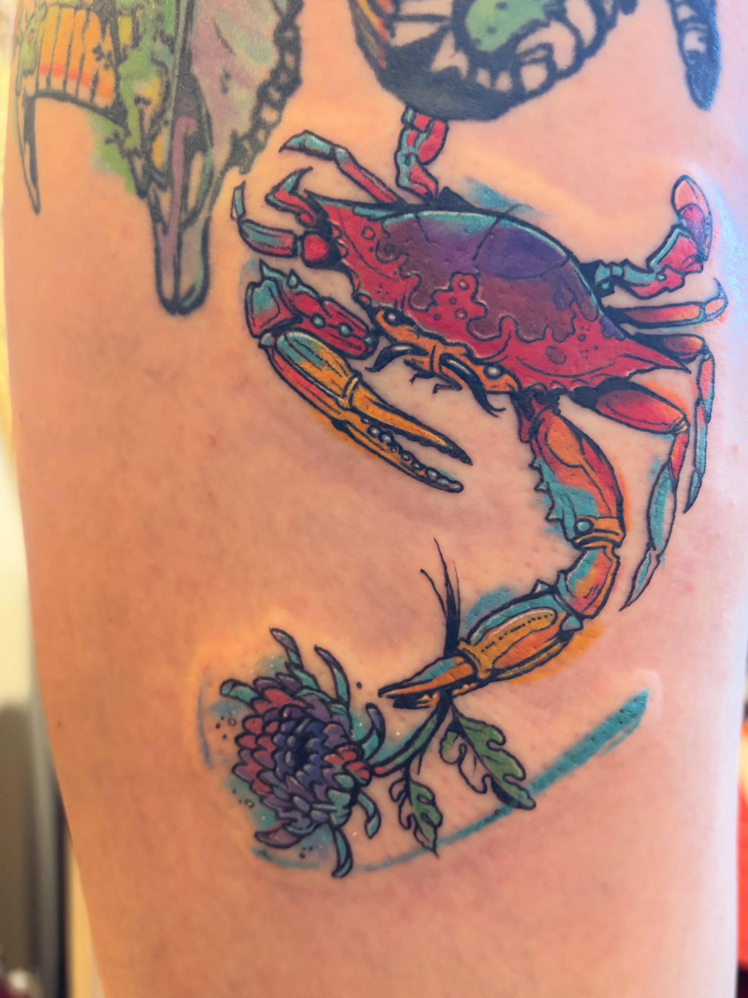 Crab and chrysanthemum American traditional tattoo on the thigh by Zoe Brookes