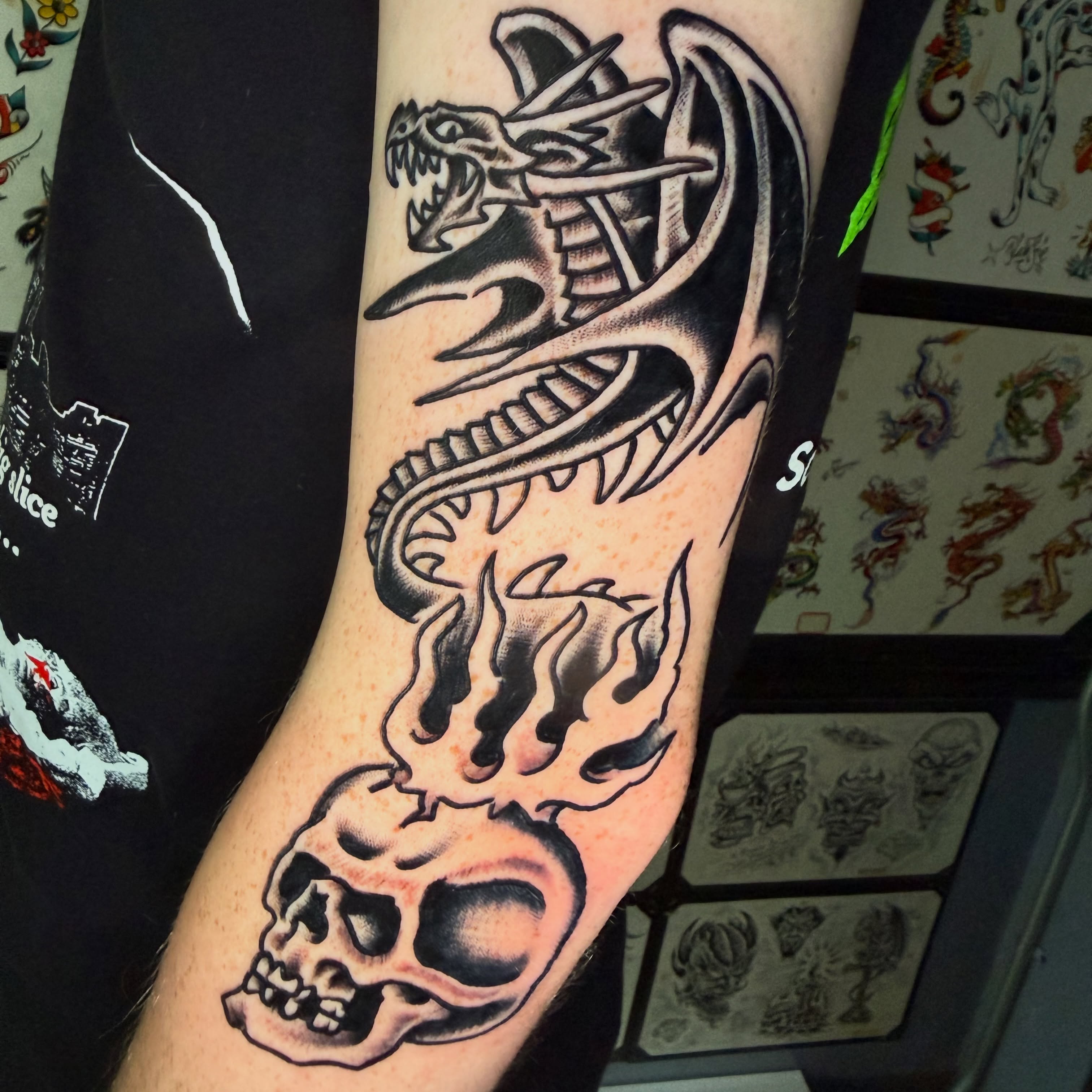 Flaming snake American traditional tattoo on the forearm by Mike Dunn