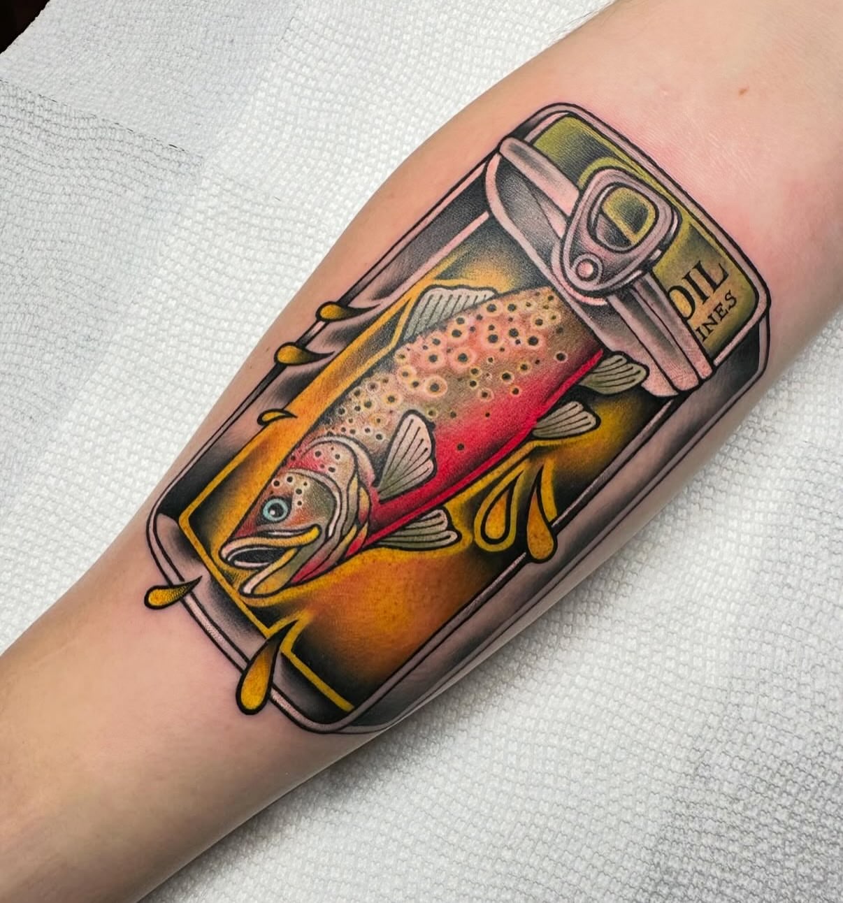 Fish in can American traditional tattoo on the forearm by Mark Boller